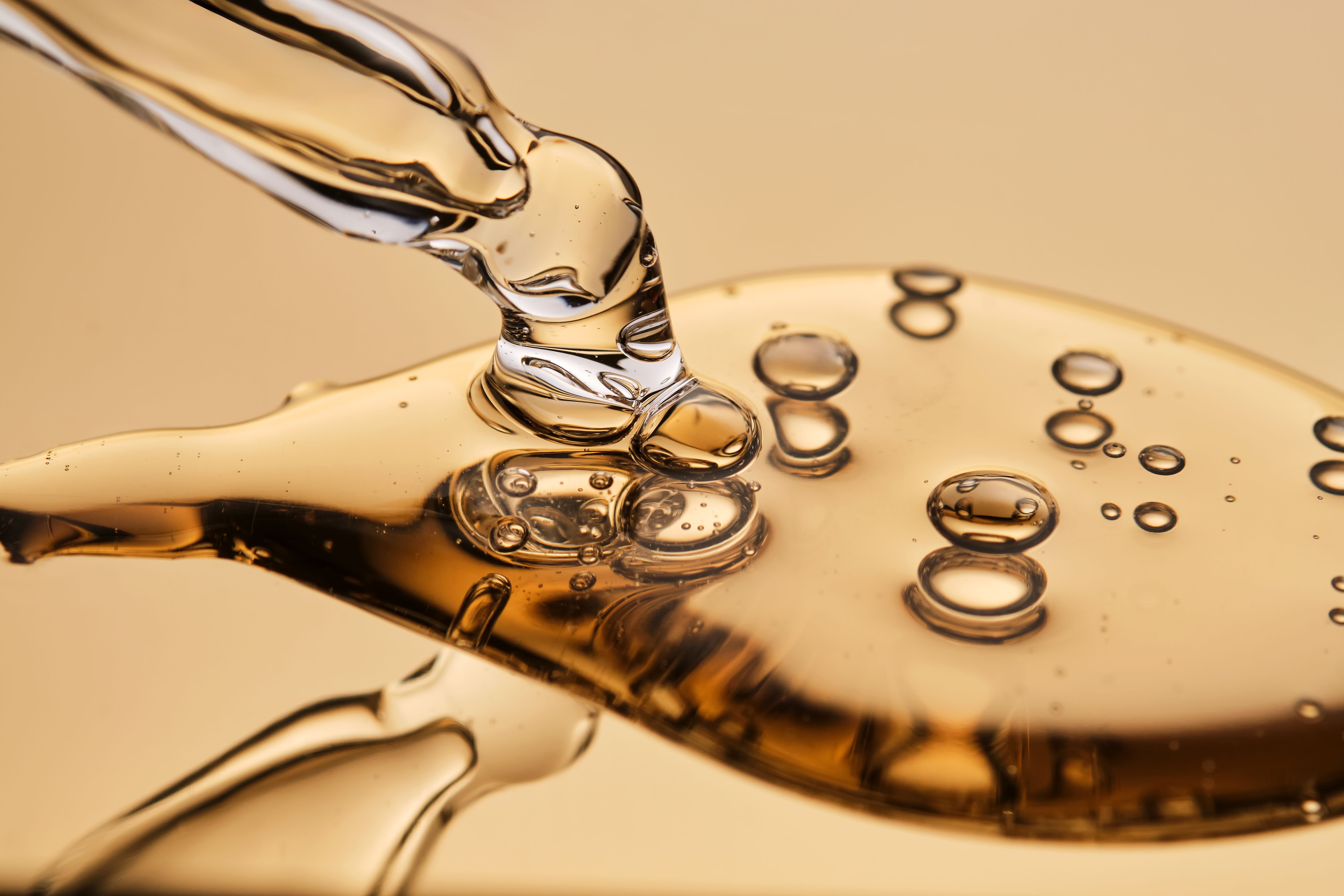 A pipette with a beautiful drop of gel-textured facial serum.