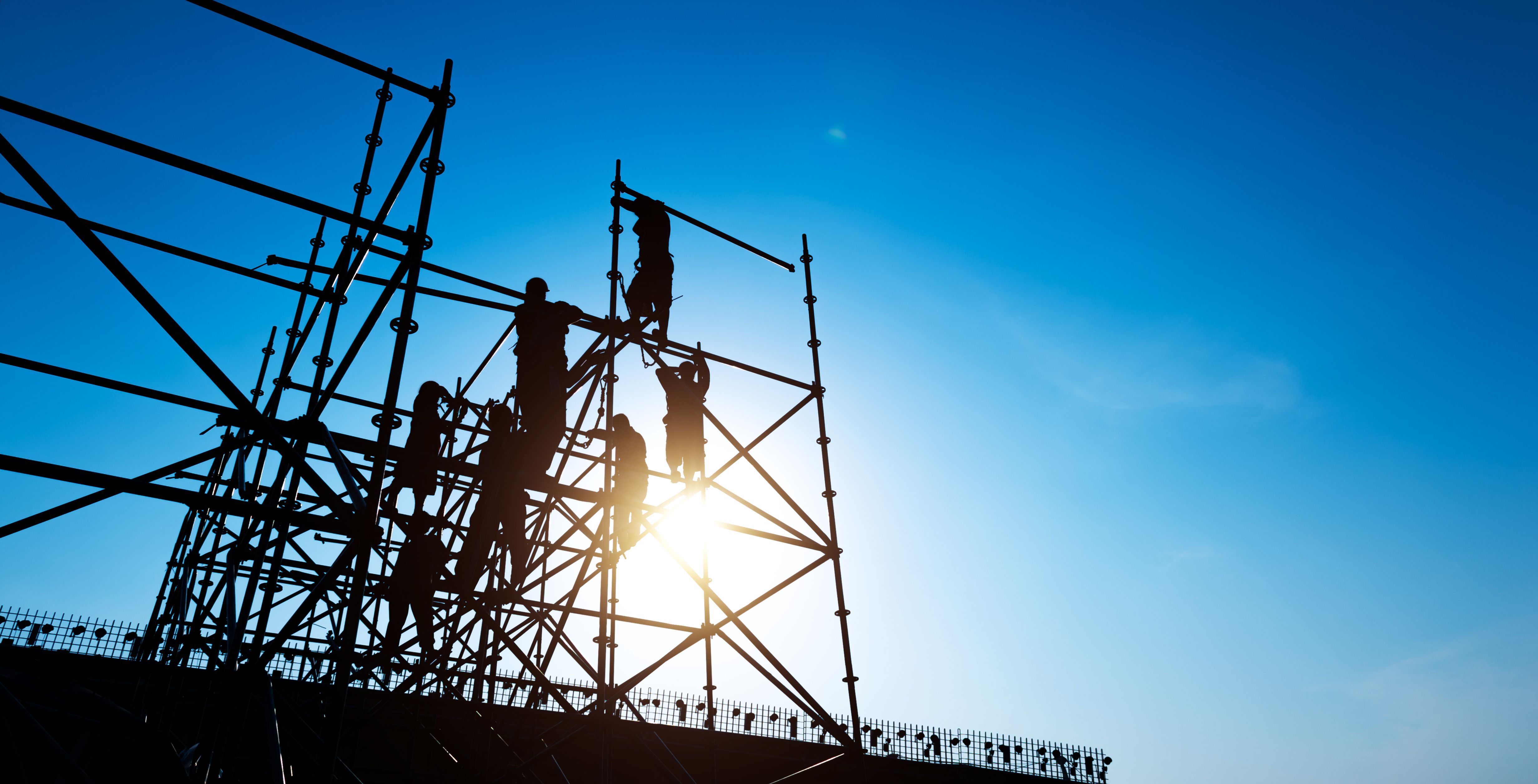 Group of construction workers working on scaffolding