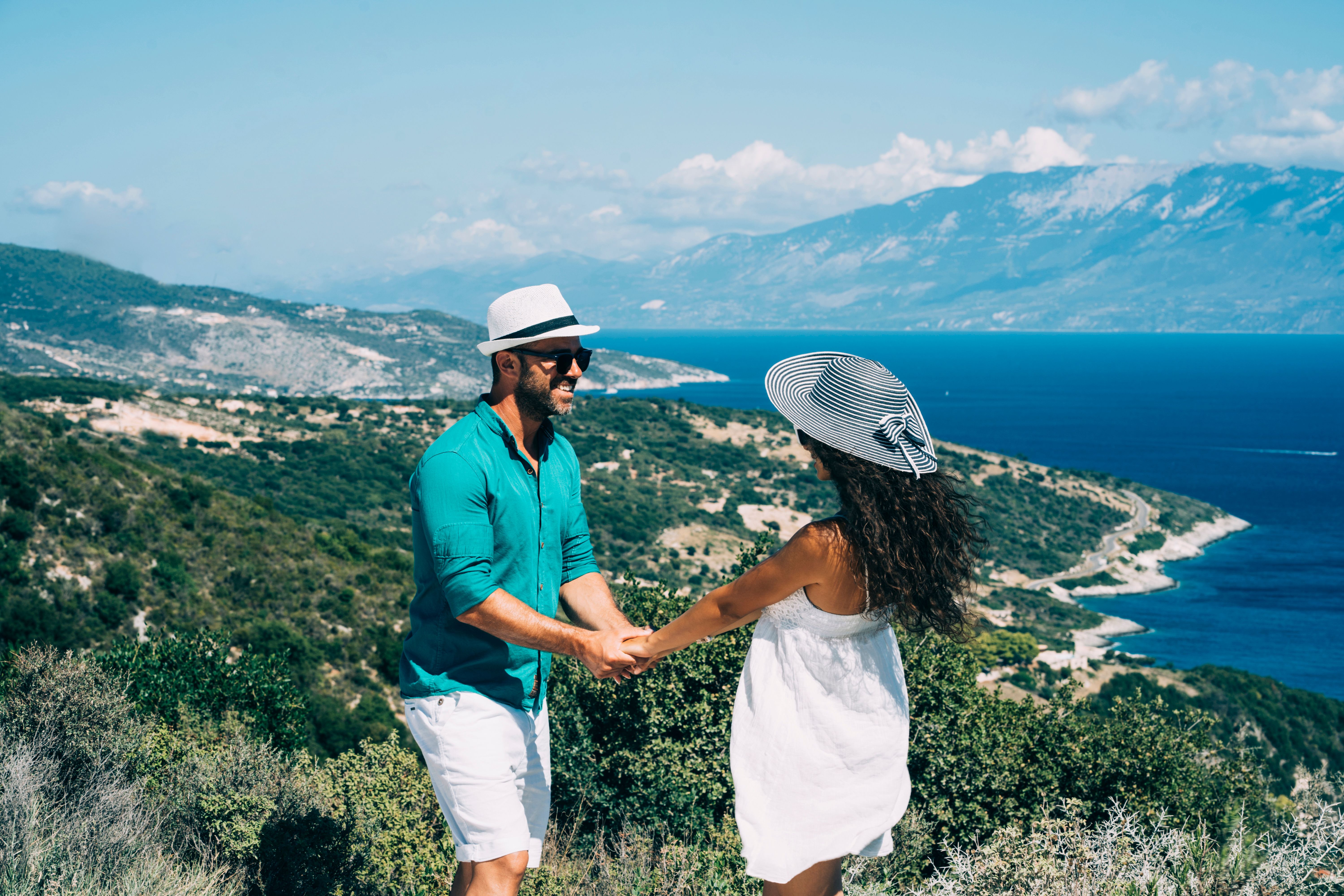 Couple holding hands and standing over Zakynthos island