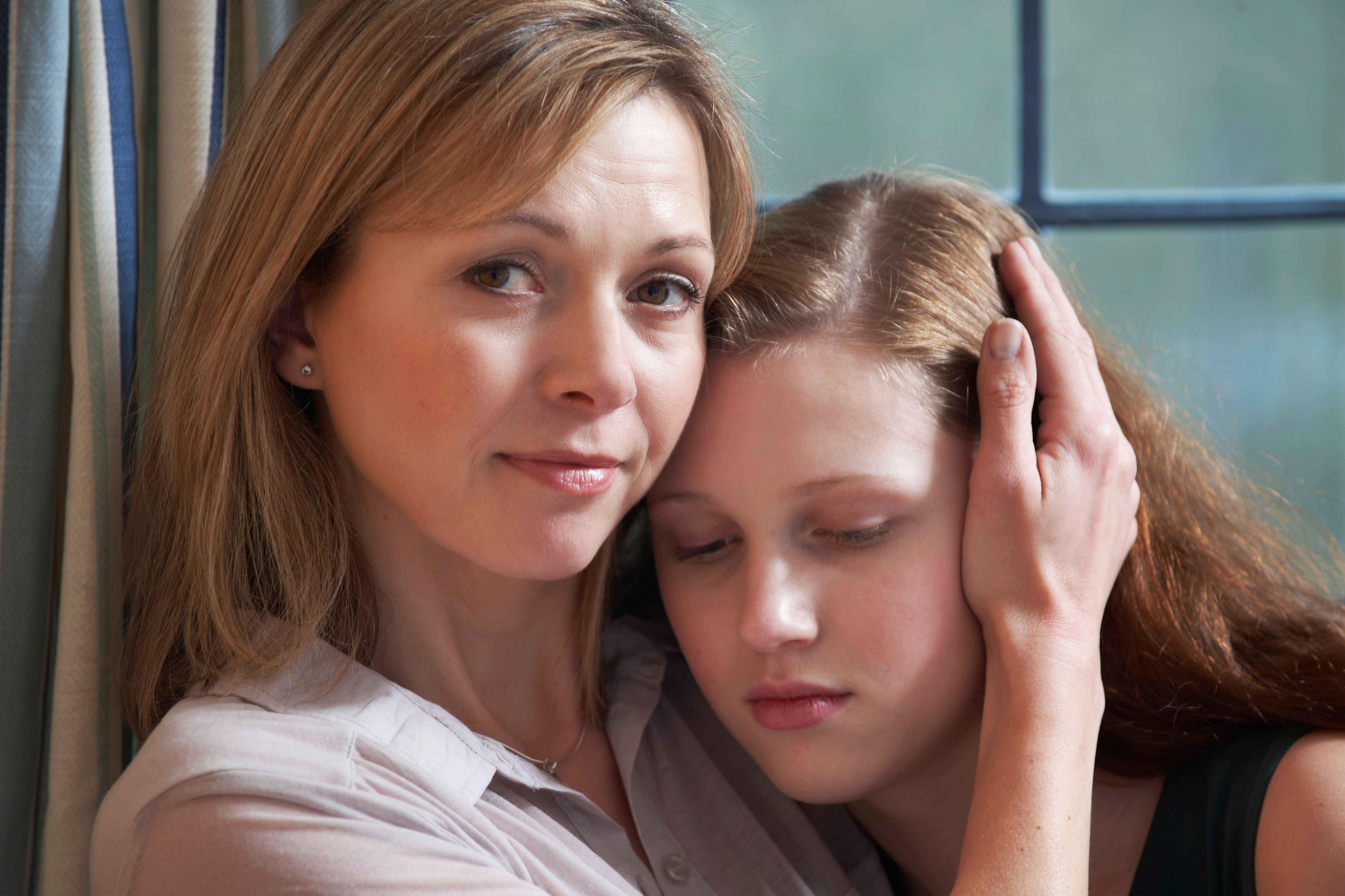 Mother comforting teenage daughter sadness Mother comforting teenage daughter sadness