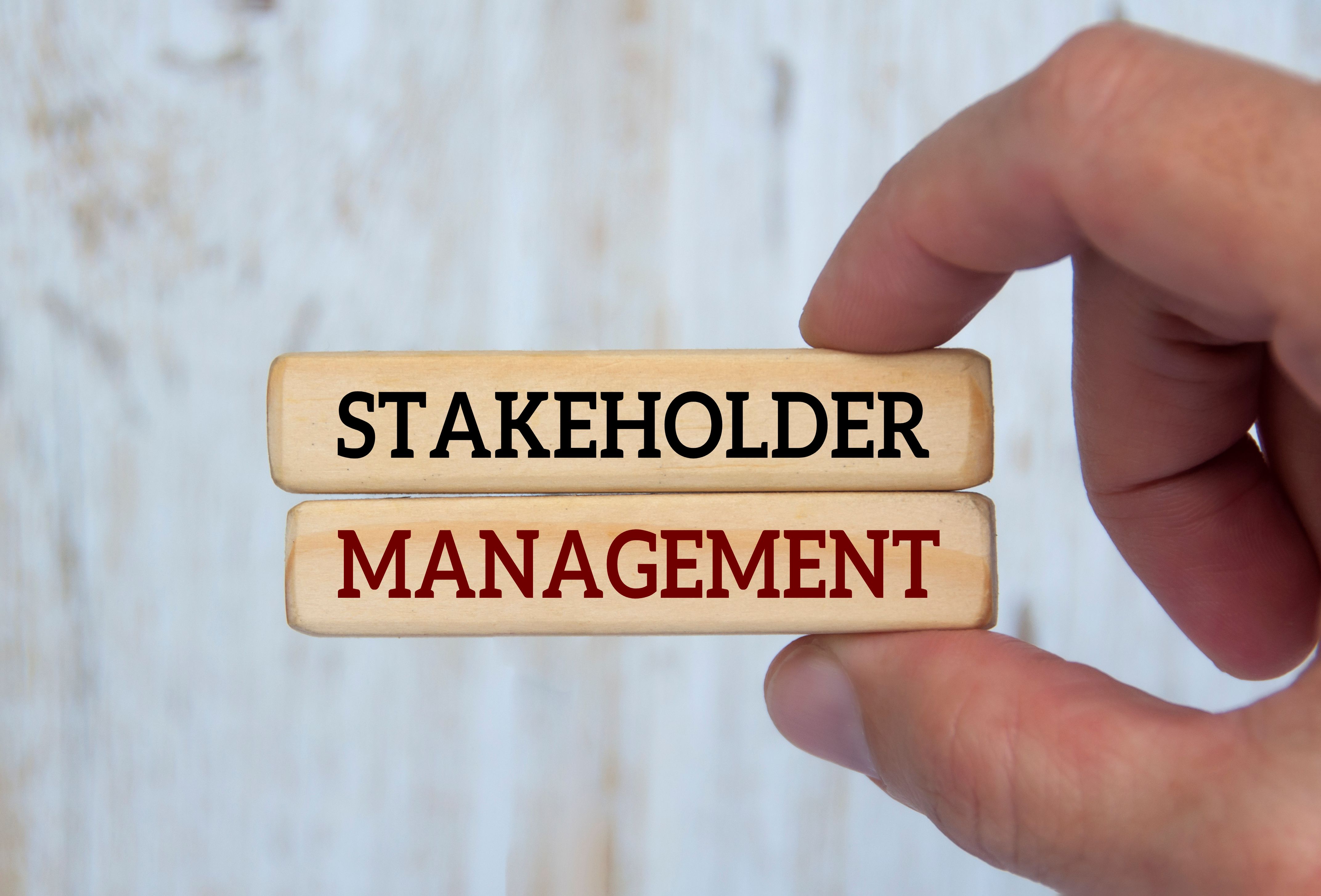 Hand holding wooden blocks with text - stakeholder management. Business relationship concept