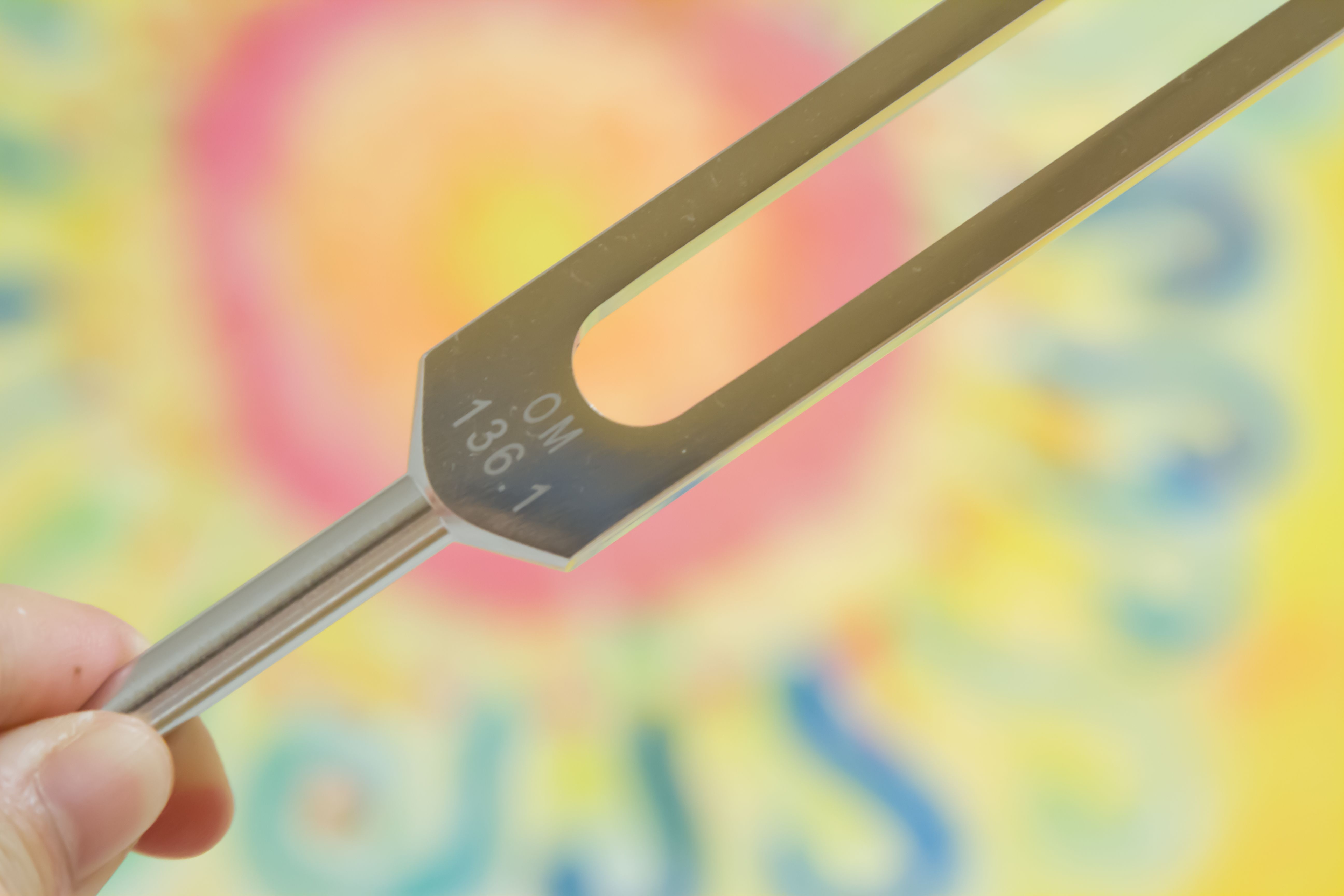 Hand holding a tuning fork . Hand holding a tuning fork .