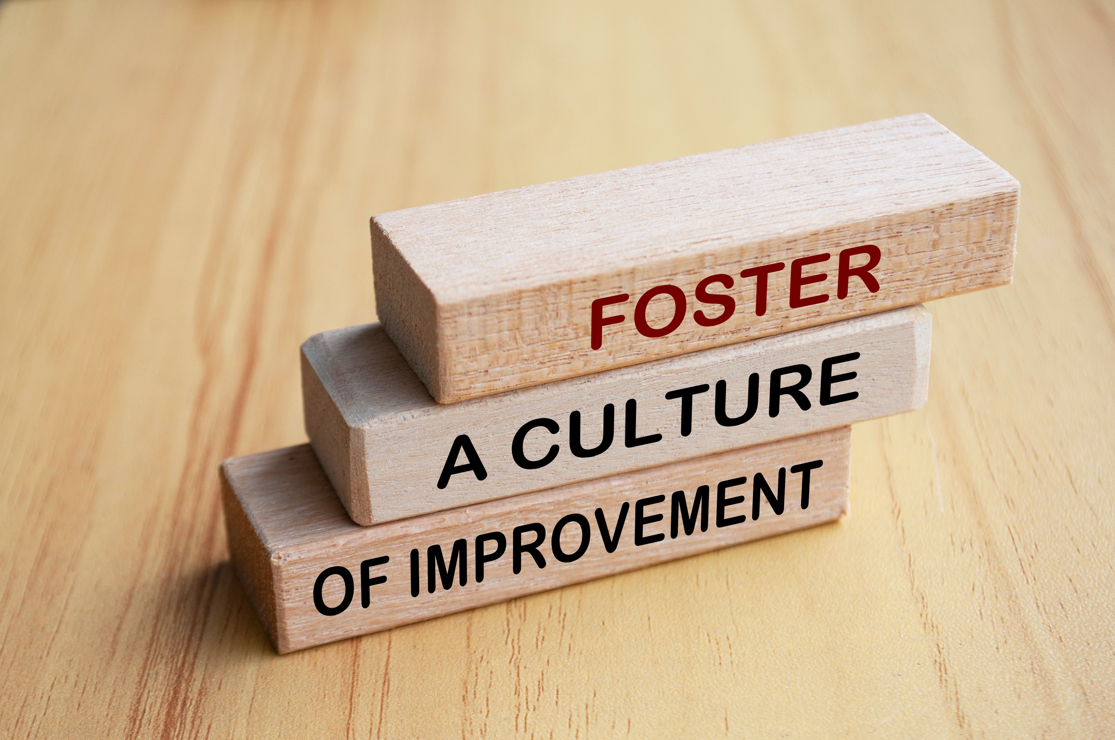 Foster a culture of improvement text on wooden blocks. Operational excellence and continuous improvement concept Foster a culture of improvement text on wooden blocks. Operational excellence and continuous improvement concept