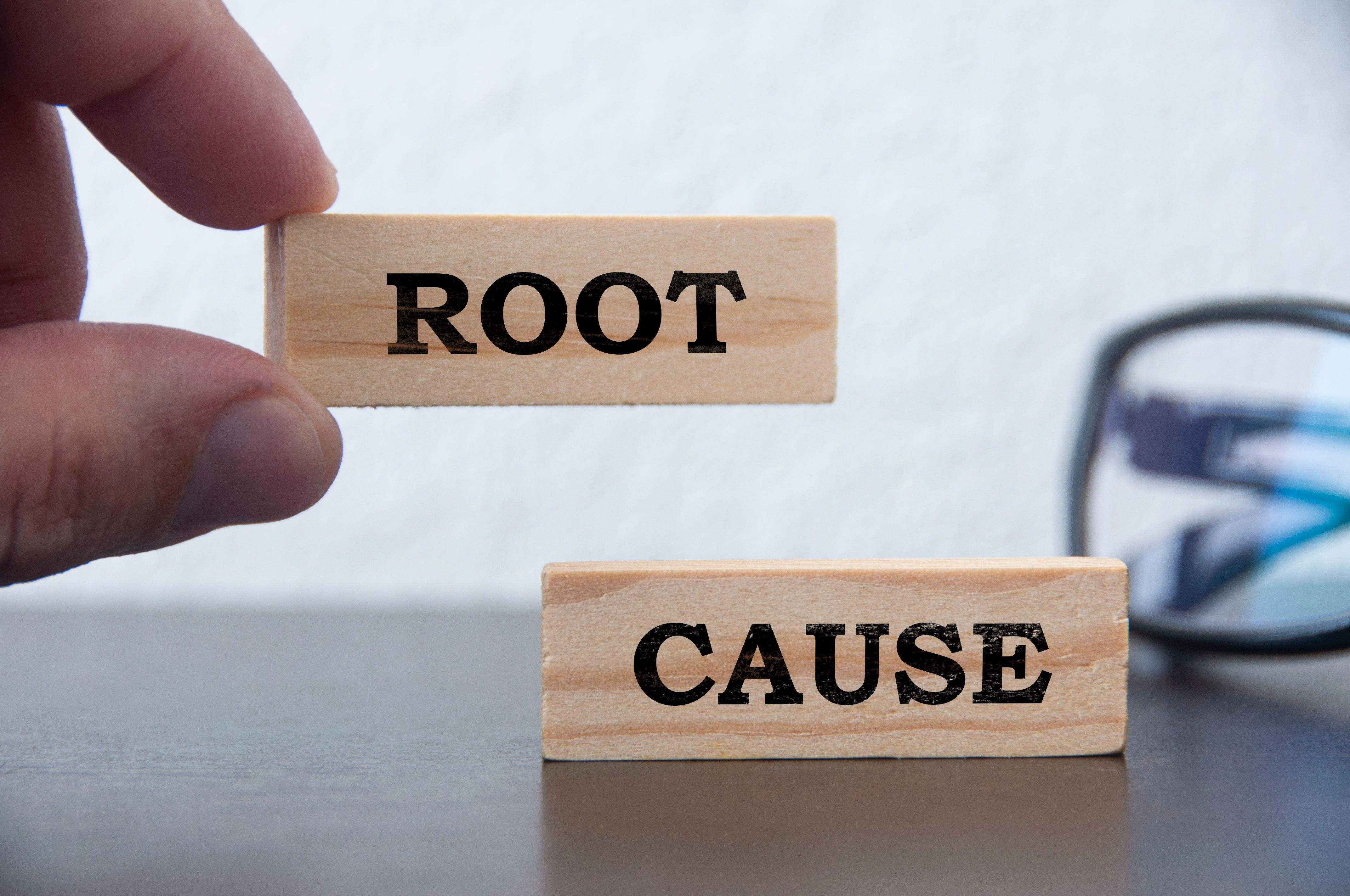 Hand holding wooden block with text - Root cause analysis. Problem solving and preventive concept