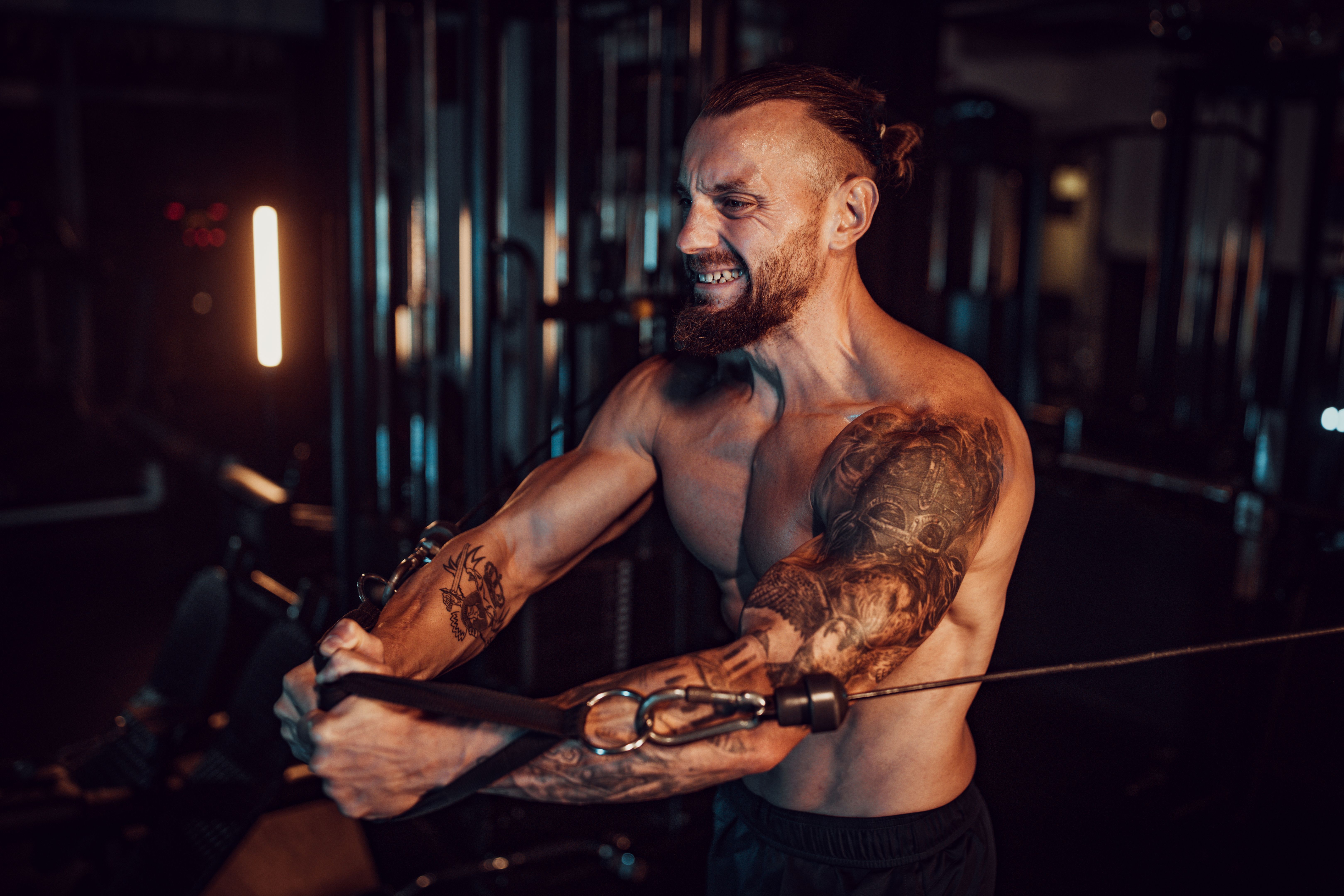 Strength-focused workout routine with tattooed athlete