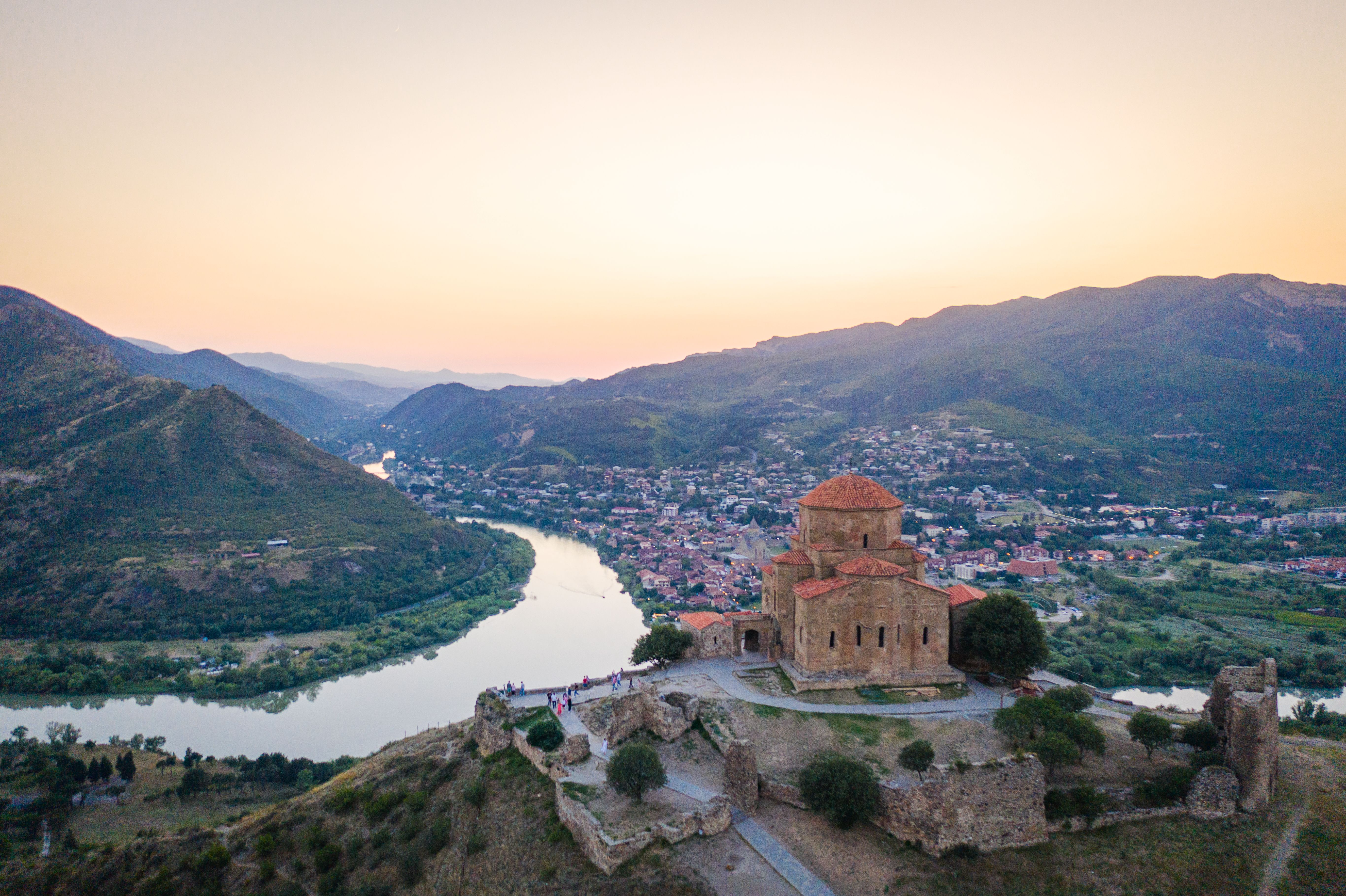 Aerial view at Jvari Monastery with Mtskheta town and river background.
