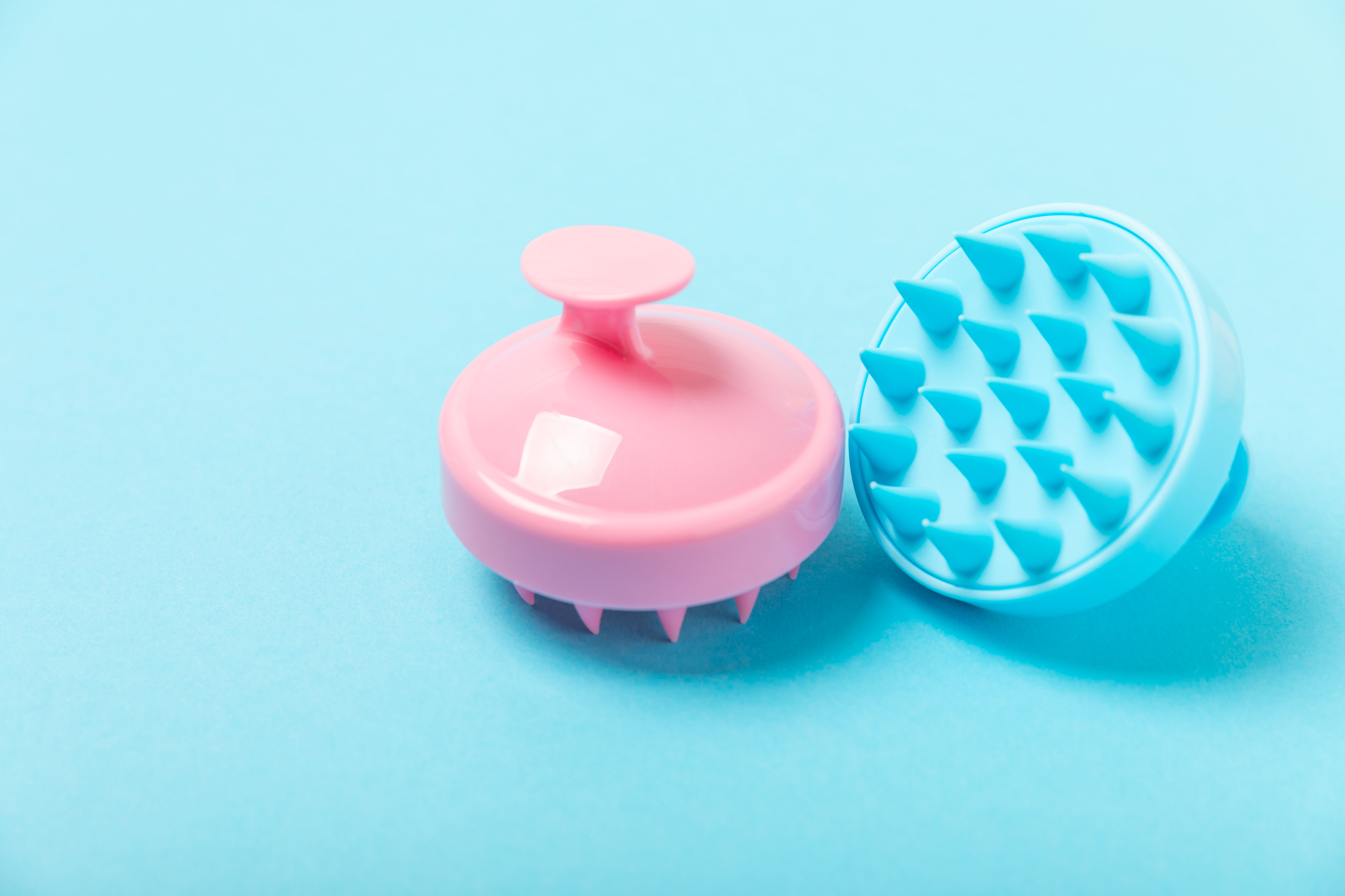 Brush for scalp massage on background. Brush for hair growth stimulating brush. Hair massage. stimulating brush. Hair care, head relaxation concept. Copy space. Brush for scalp massage on background. Brush for hair growth stimulating brush. Hair massage. stimulating brush. Hair care, head relaxation concept. Copy space.