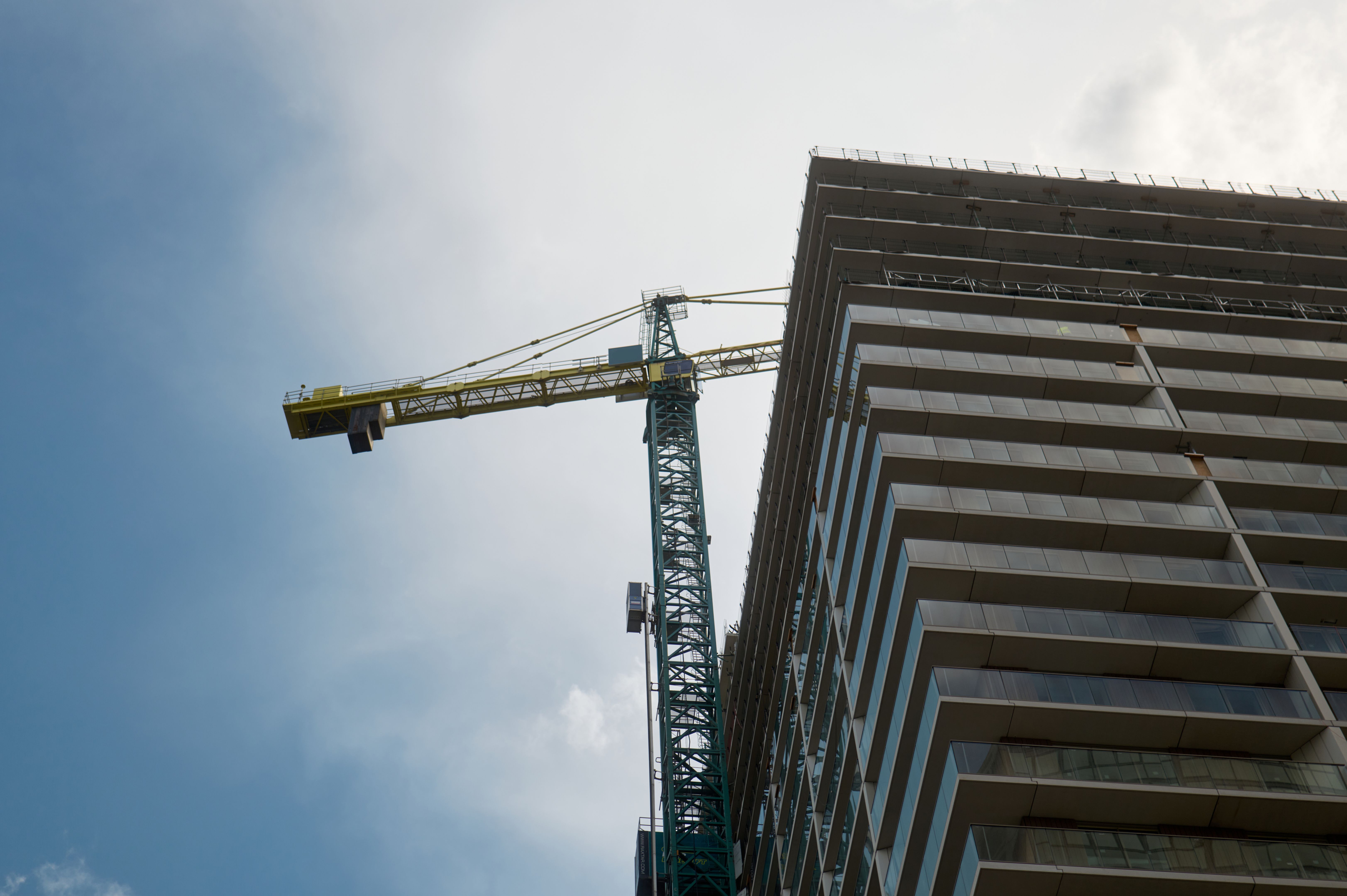 Construction crane building modern skyscraper in urban city