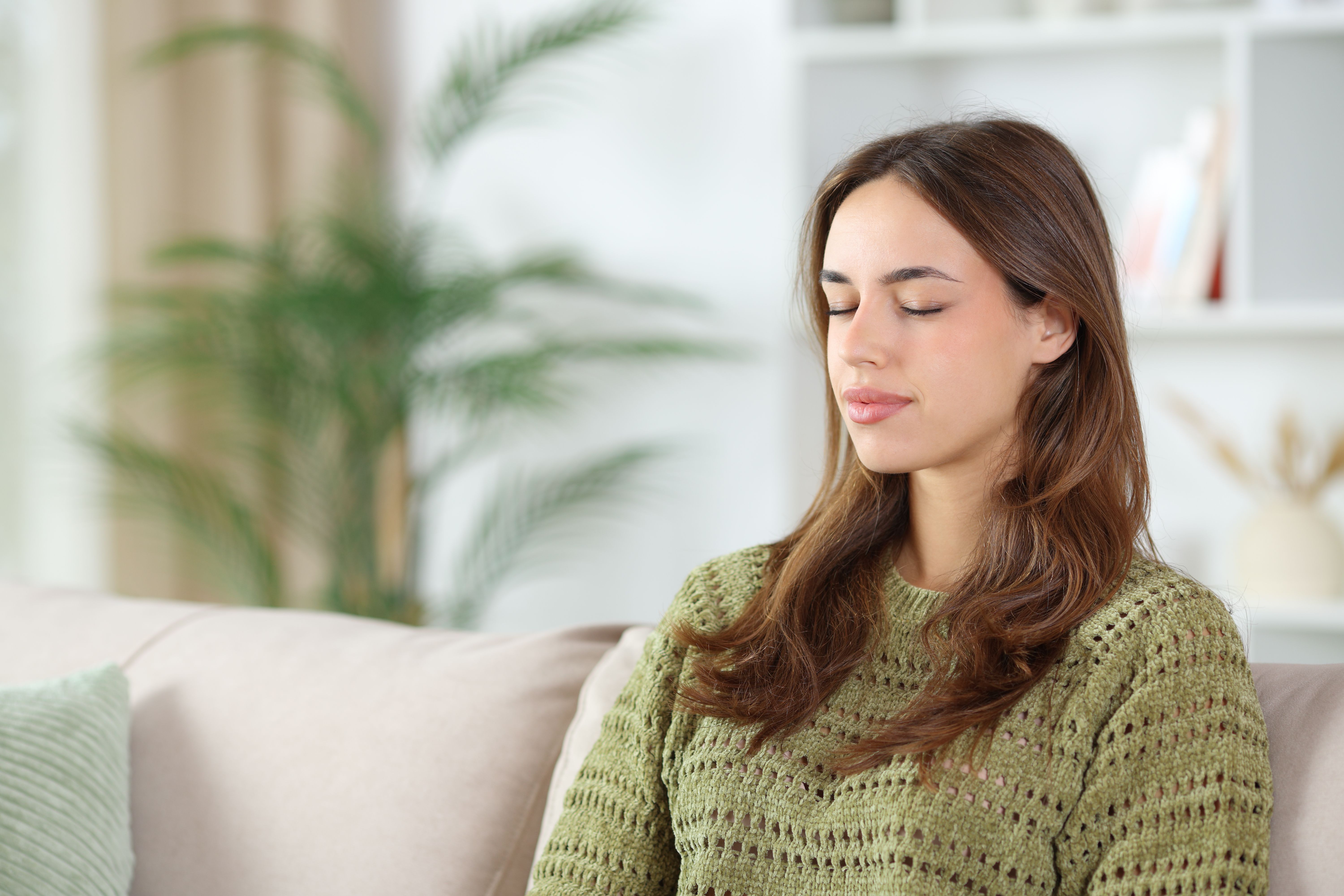  woman relaxing closing eyes feeling safe