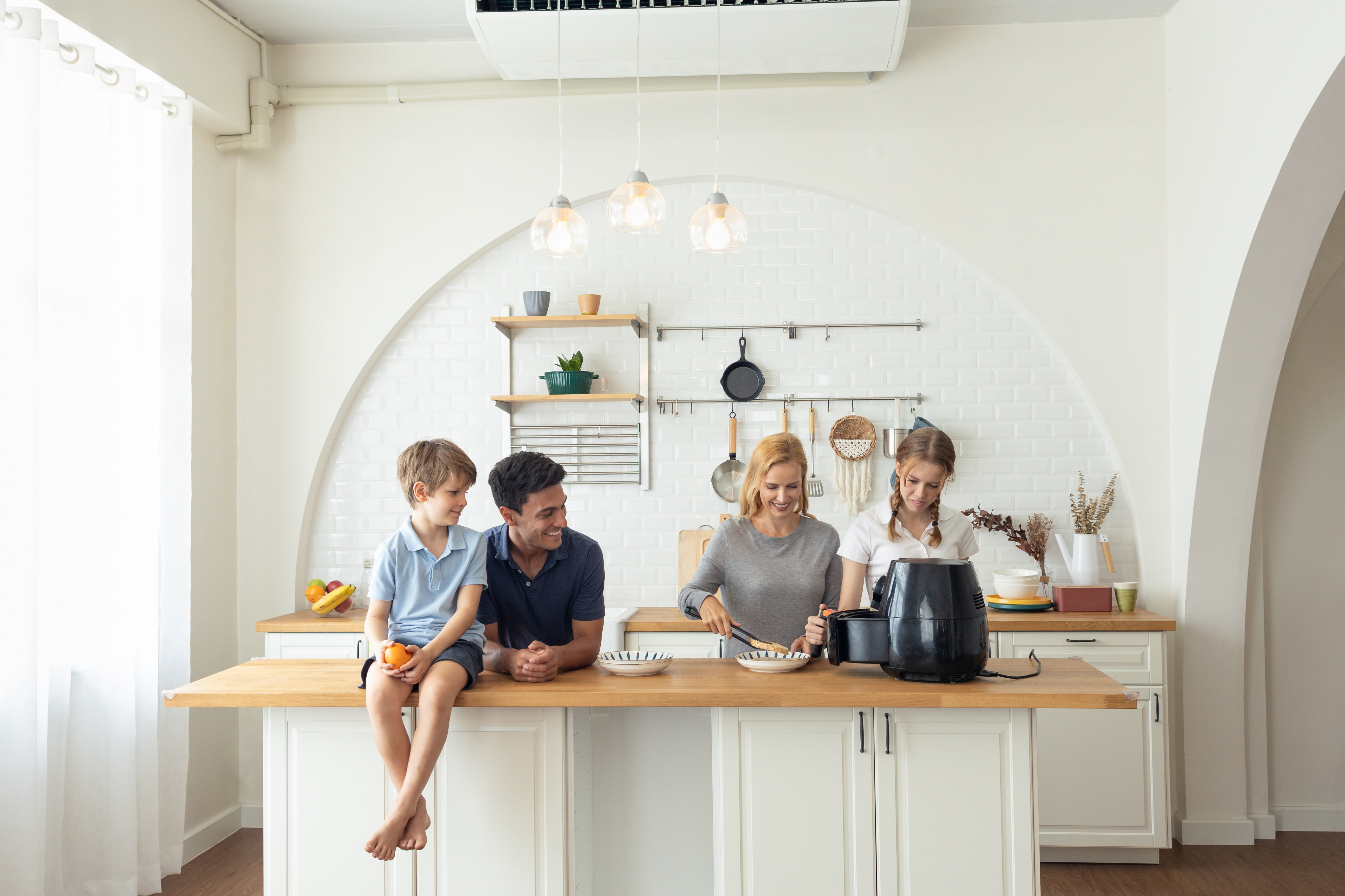 The Caucasian family Make breakfast with the air fryer together. father, mother, daughter and sons Cooking in the kitchen together at home. Happy family relationship and technology concept The Caucasian family Make breakfast with the air fryer together. father, mother, daughter and sons Cooking in the kitchen together at home. Happy family relationship and technology concept