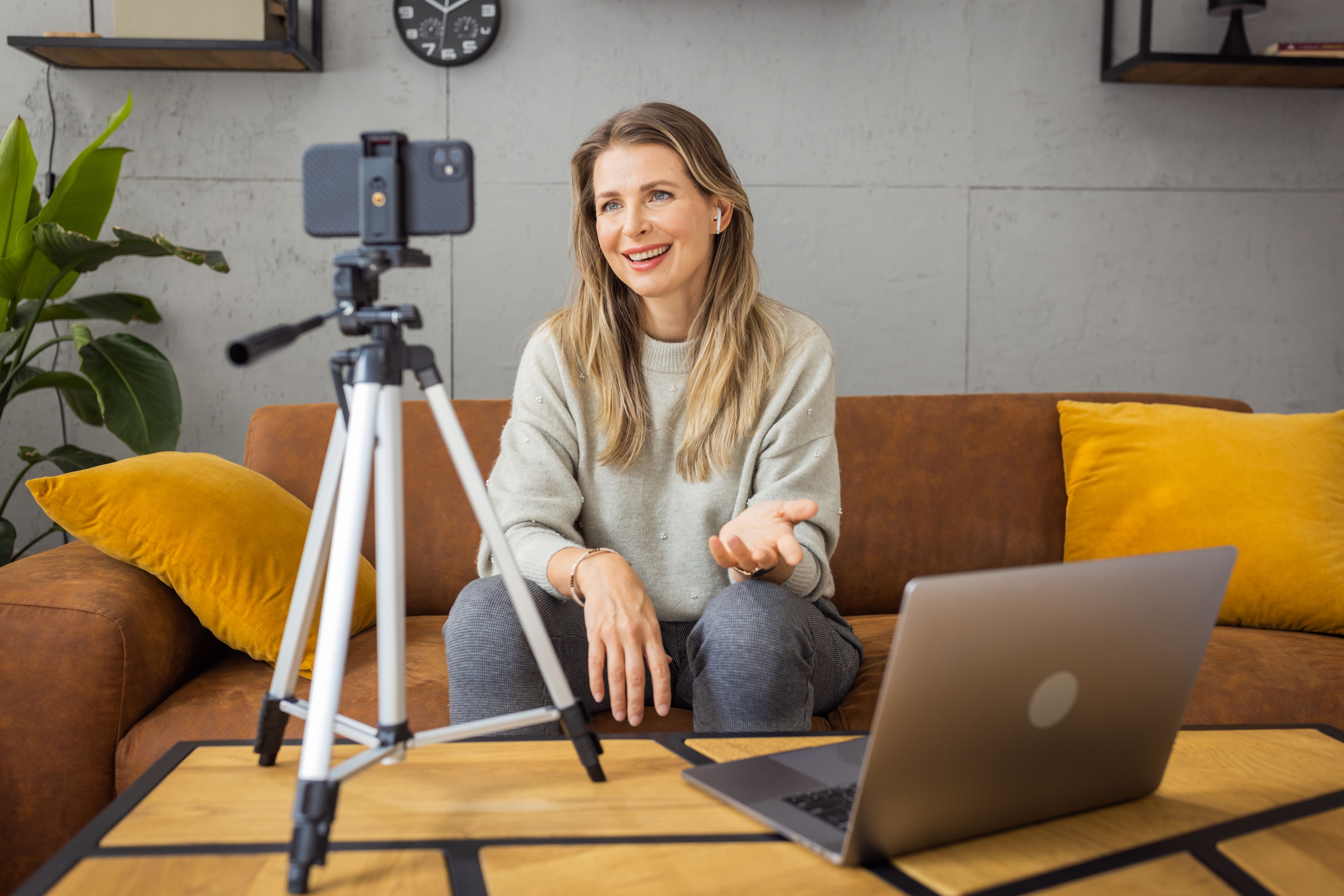 Mature woman filming vlog at home