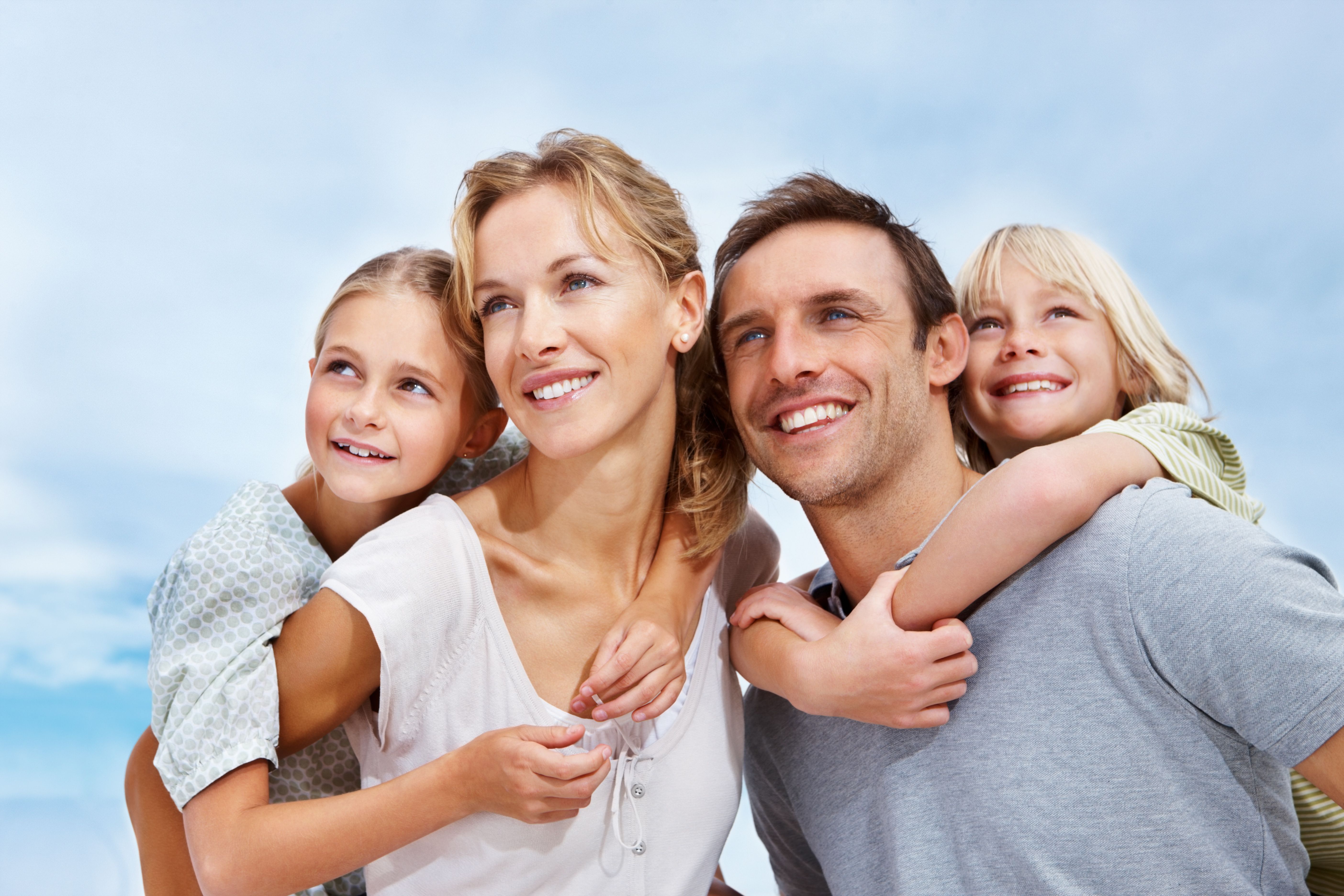 family smiling outdoors