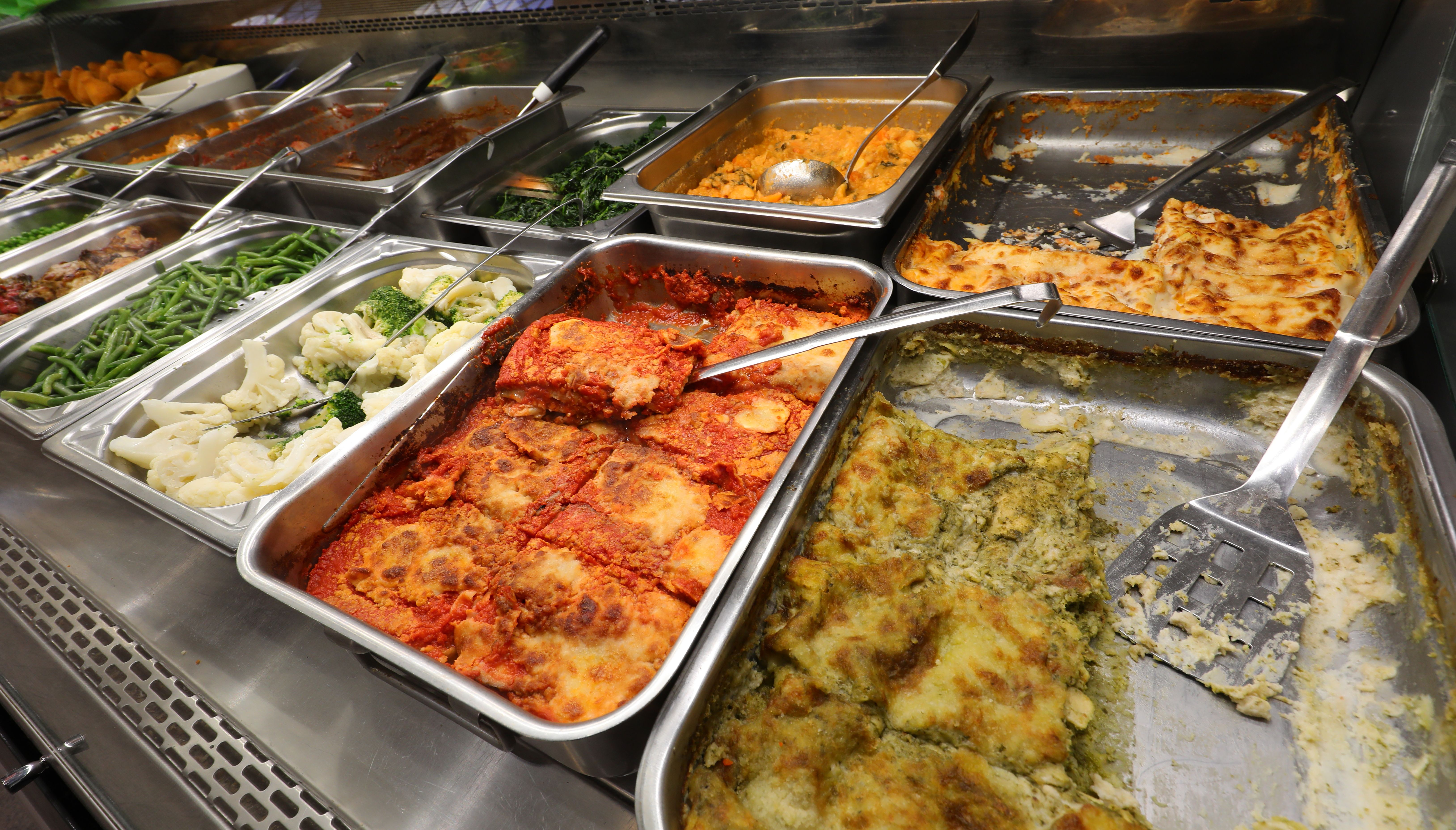 stainless steel trays filled with good food from the catering service