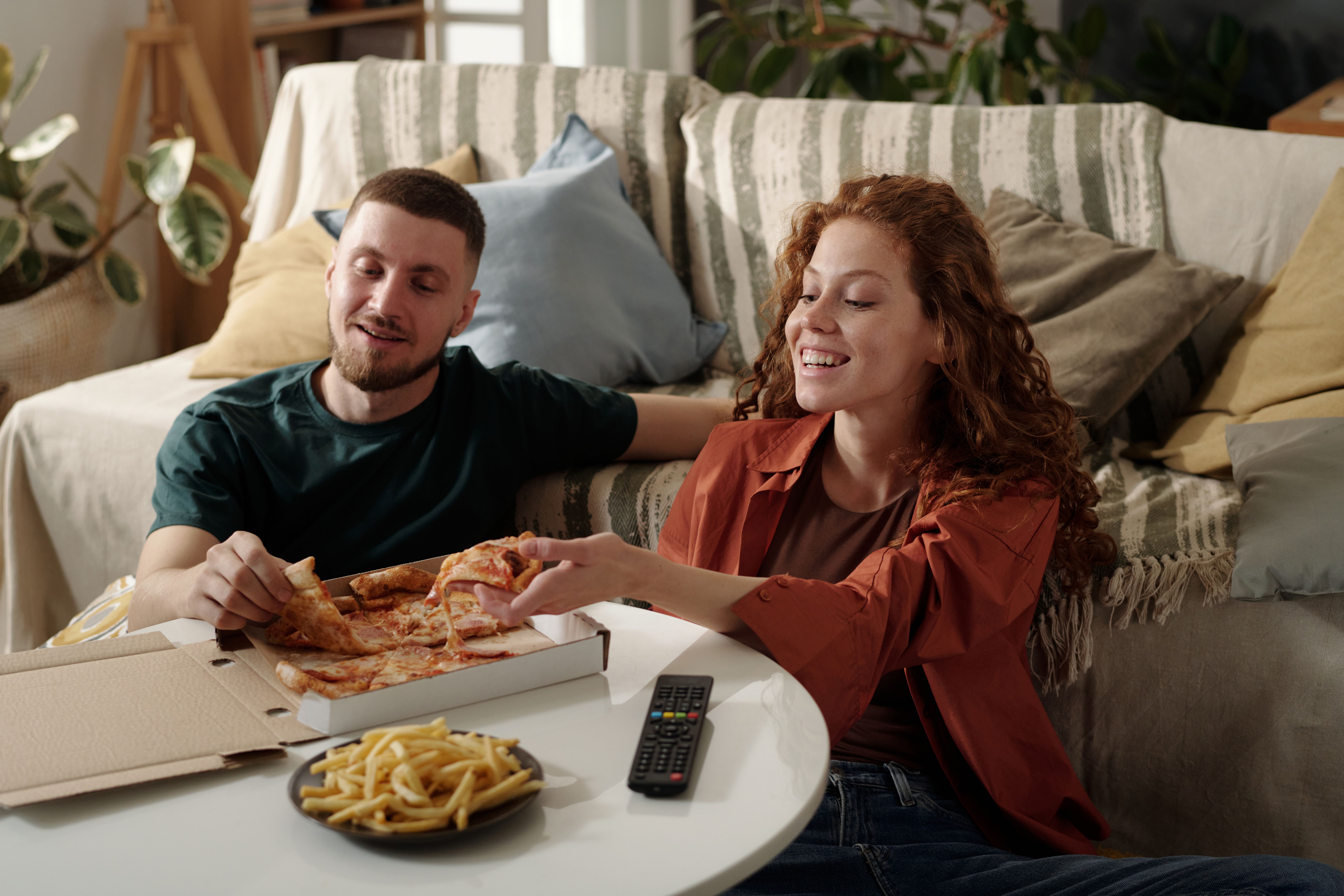 people enjoying pizza
