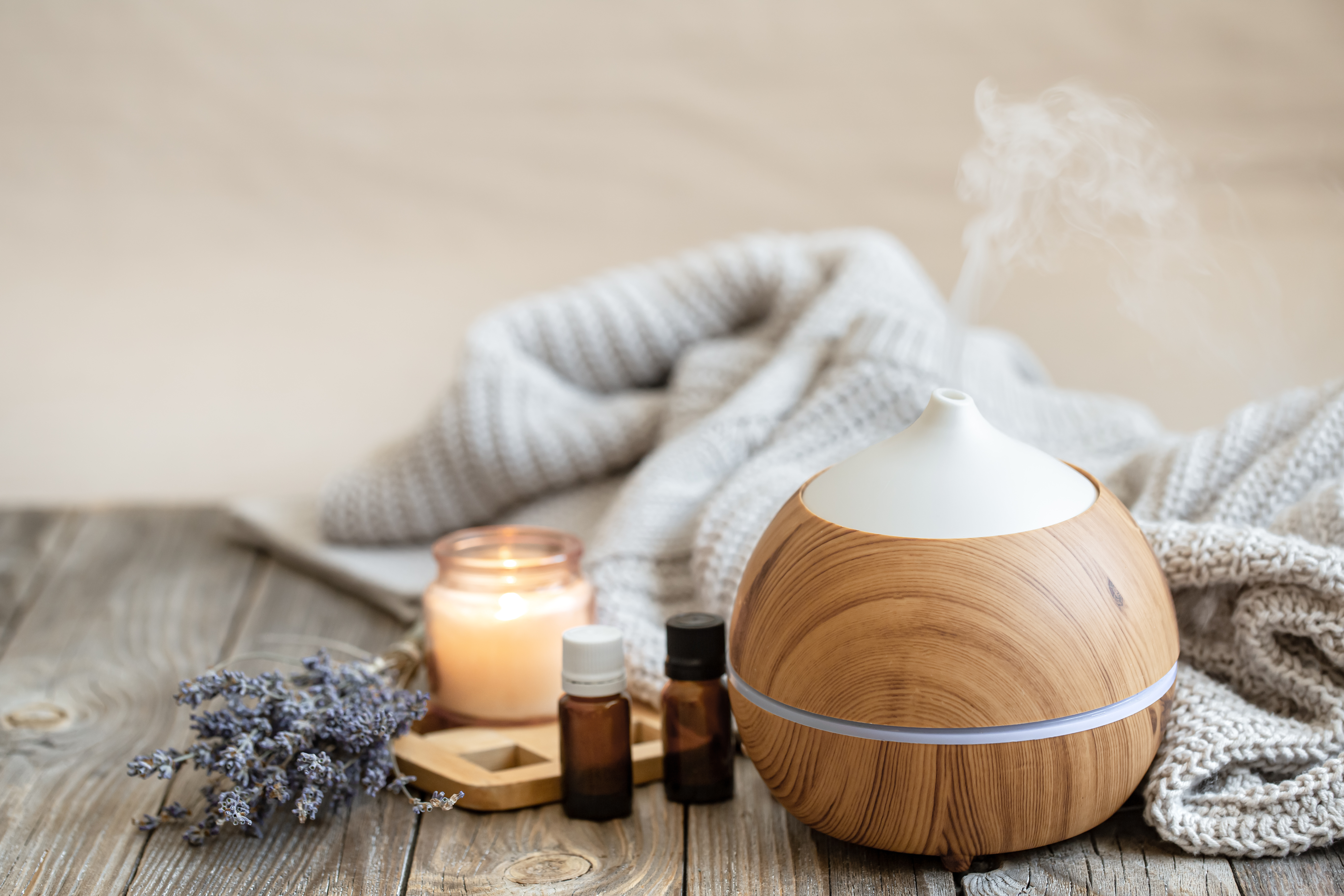 Cozy composition with an air humidifier, a set of aromatic oils and a candle. Cozy composition with an air humidifier, a set of aromatic oils and a candle.
