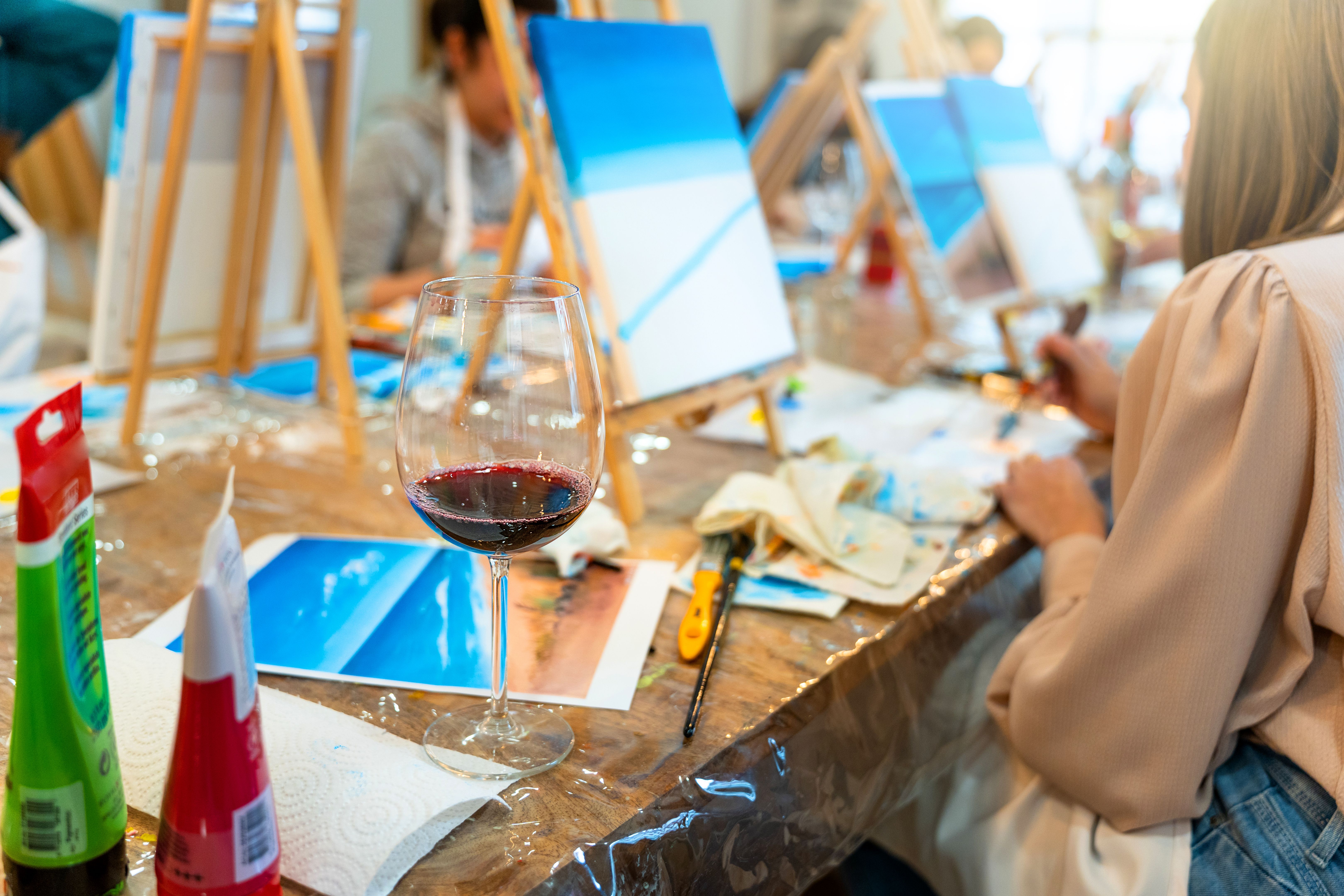 Sip and Paint Event. Painting with a glass of wine in hand Sip and Paint Event. Painting with a glass of wine in hand