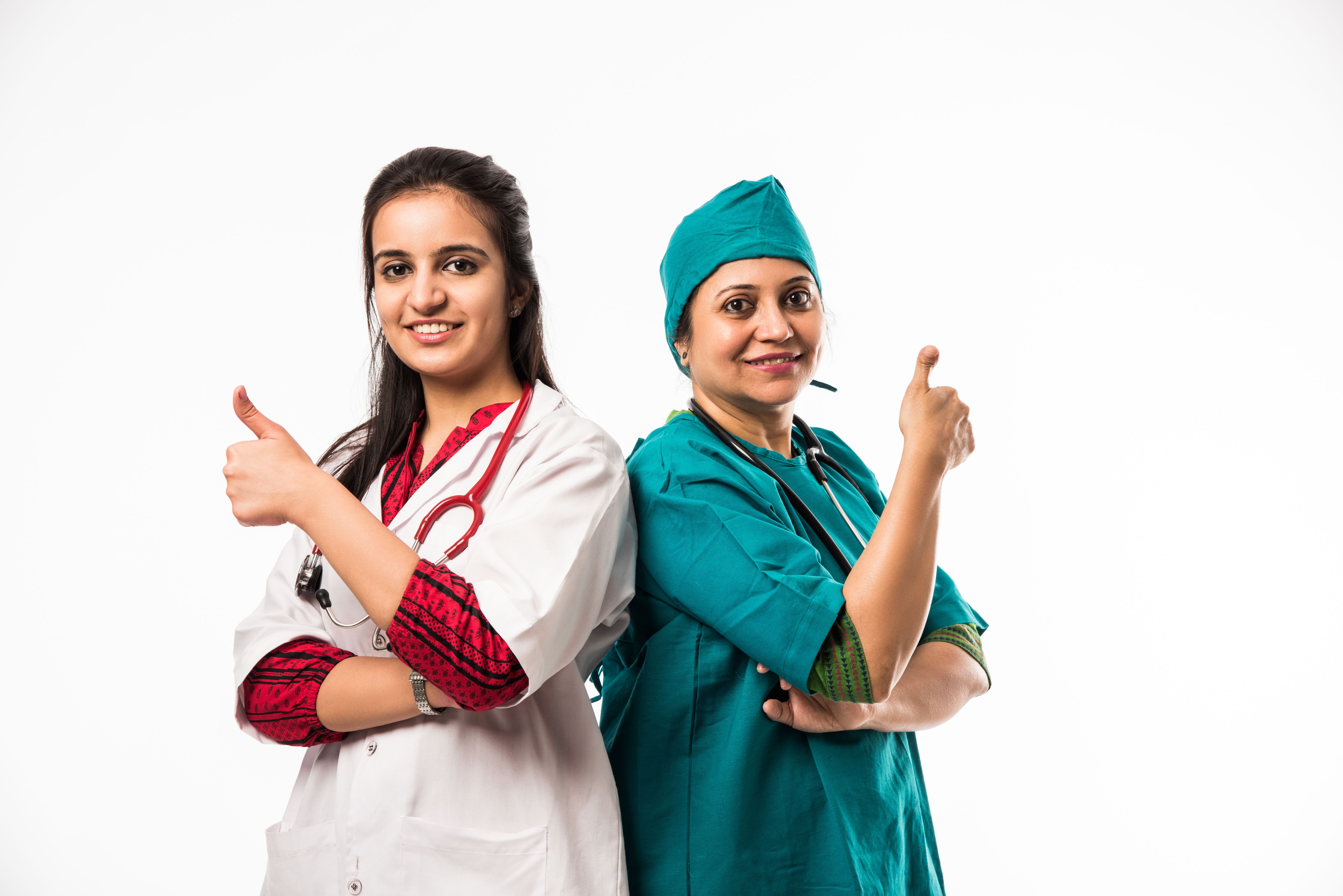 Indian/asian male and female doctor / medical professional in uniform with hands folded. standing isolated over white background