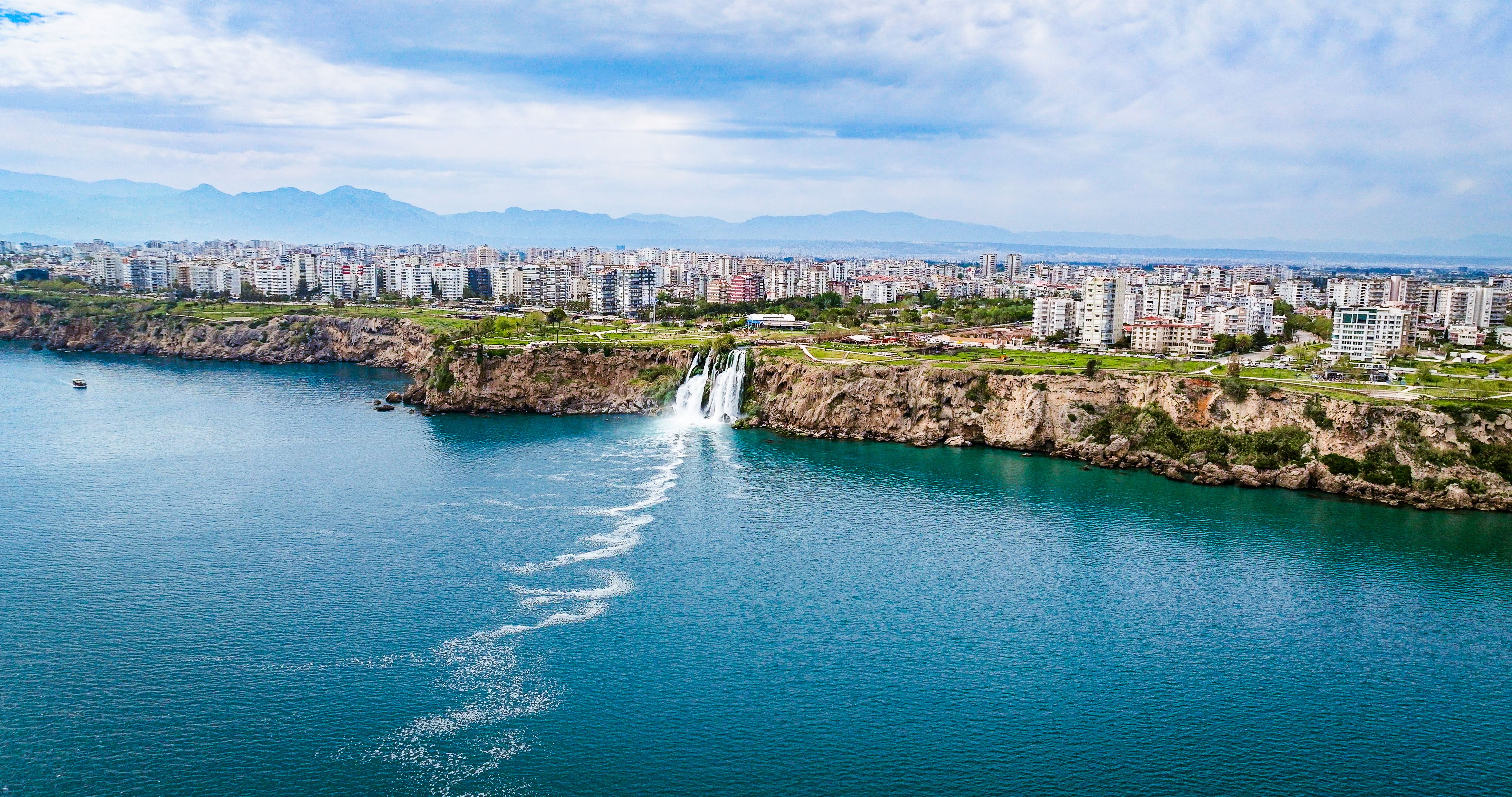 Duden waterfall dropping in Mediterranean Sea in Antalya, Lara Antalya in a bright sunny day, Lower Duden Waterfalls, high waterfall pouring into the sea, the waterfall in the city falls into the sea, turkey's famous tourism destination, the highest water