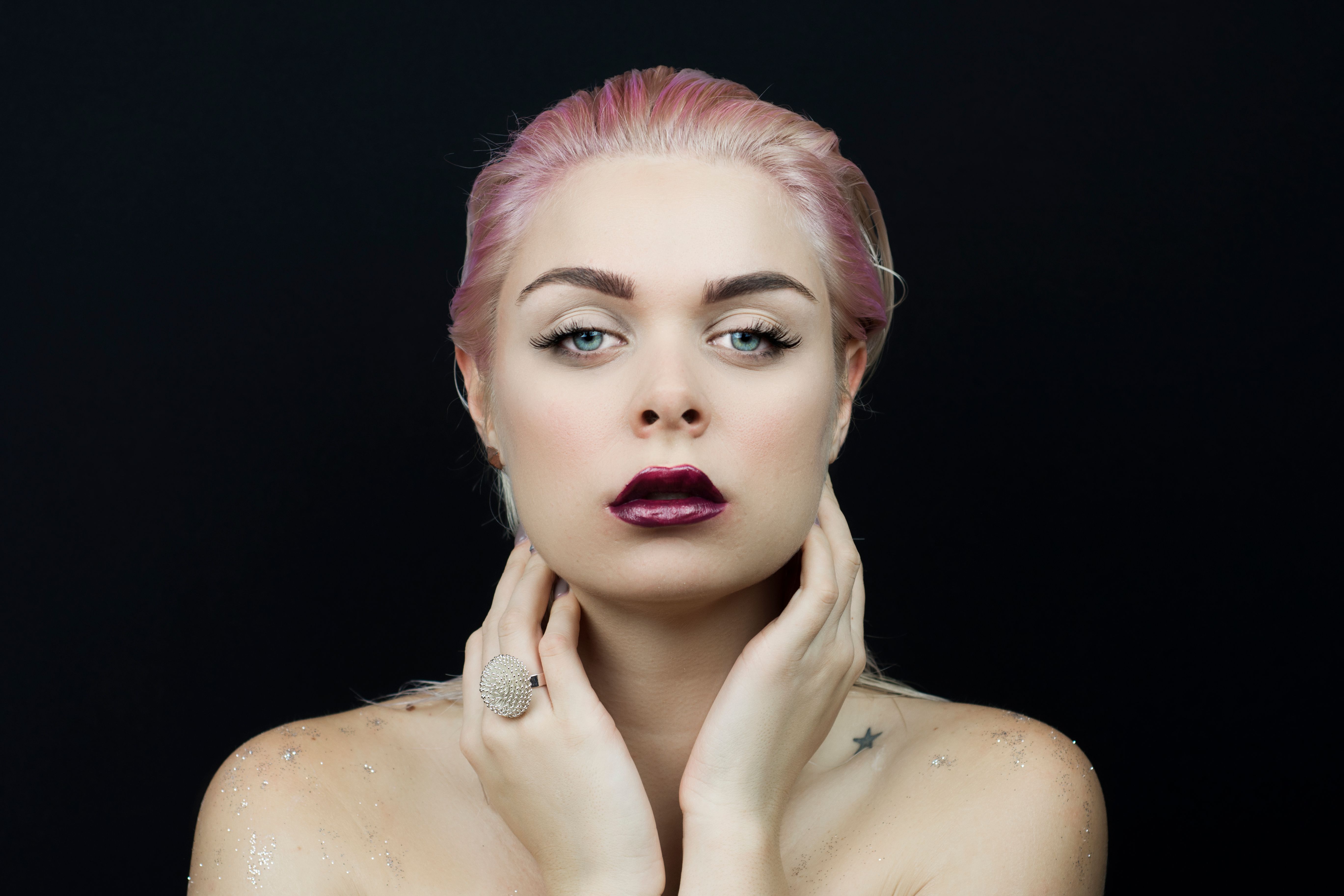 Sexy blonde woman with wet hair beauty on black