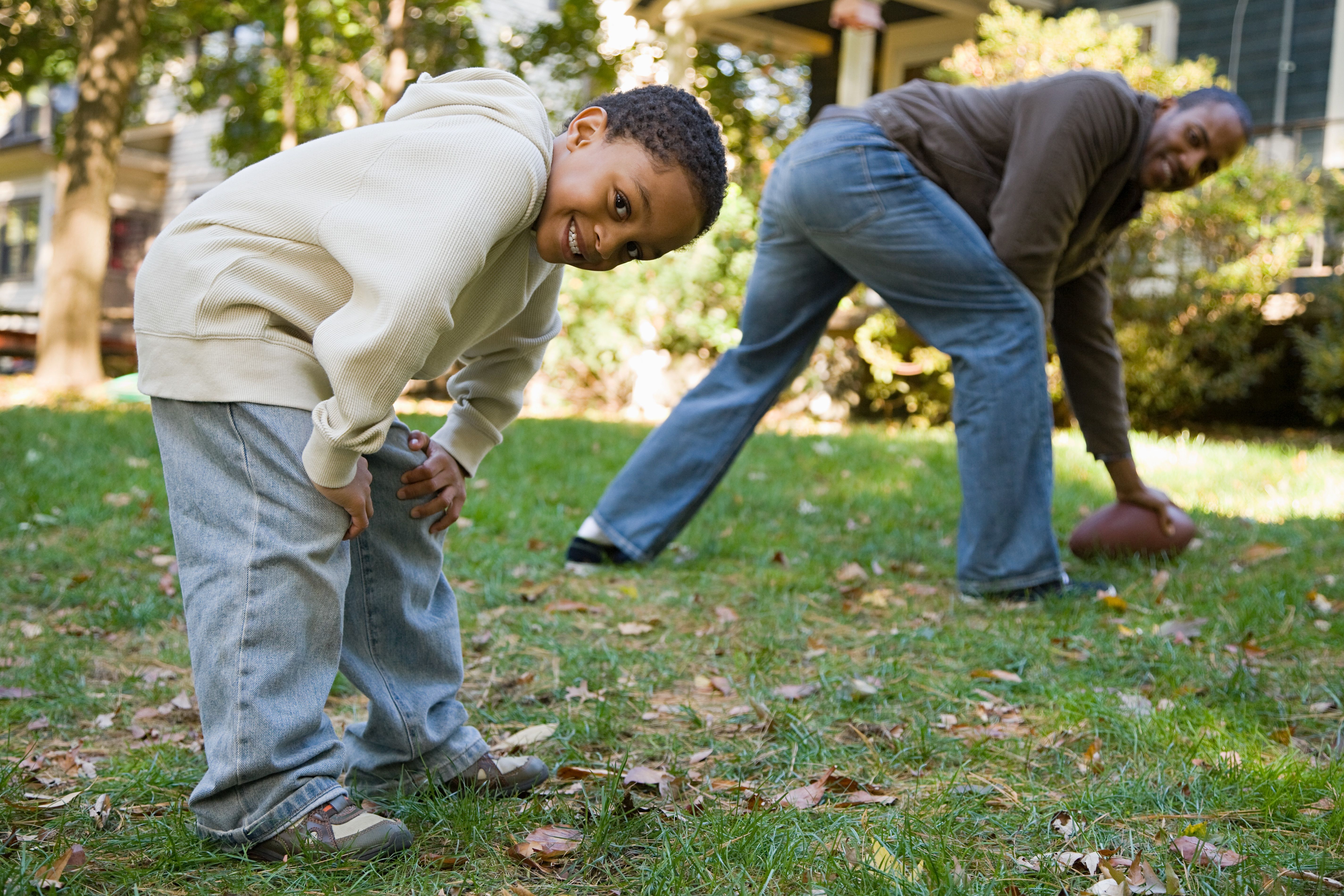 Father and son playing football