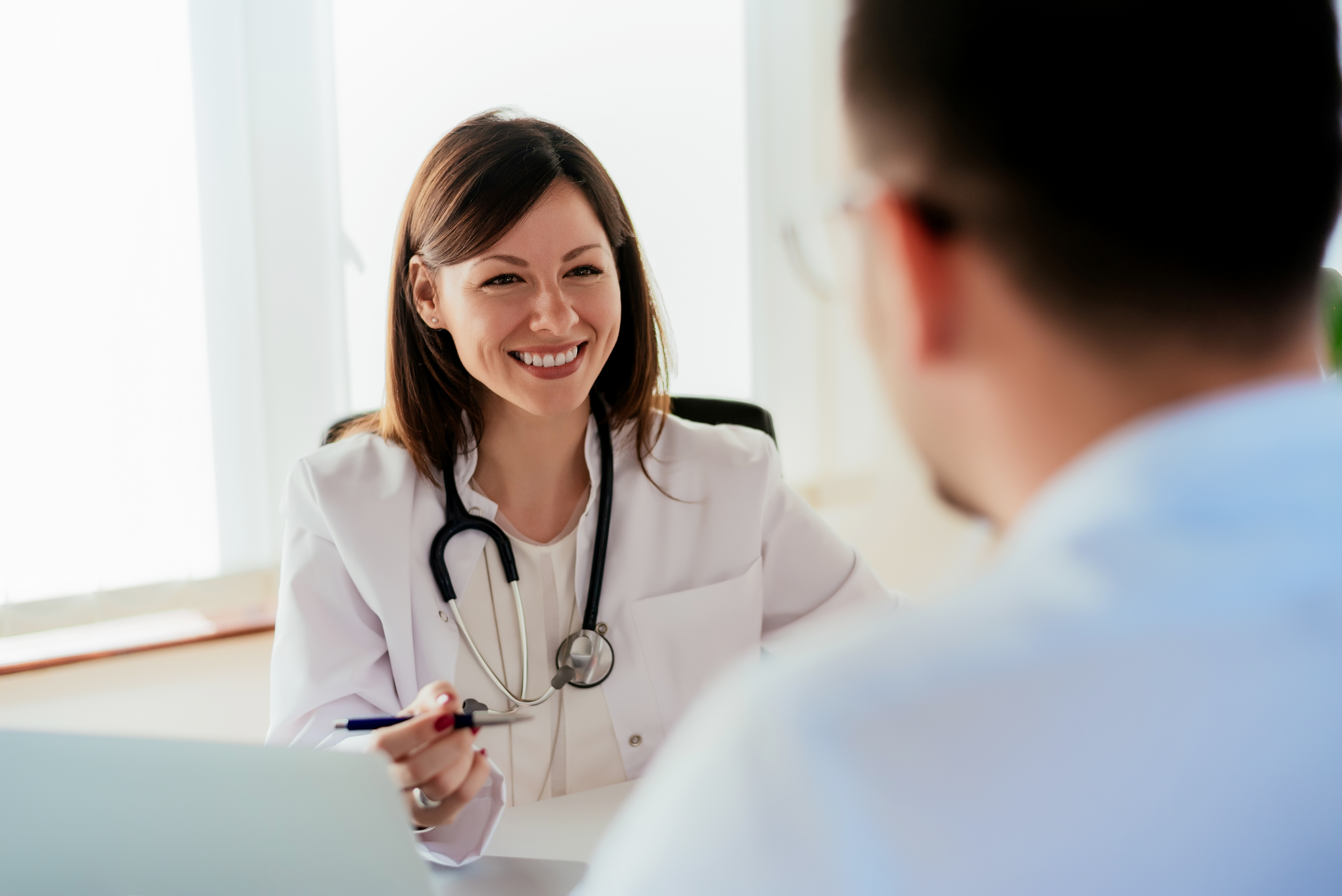 Female doctor giving a consultation to a patient and explaining medical informations and diagnosis.