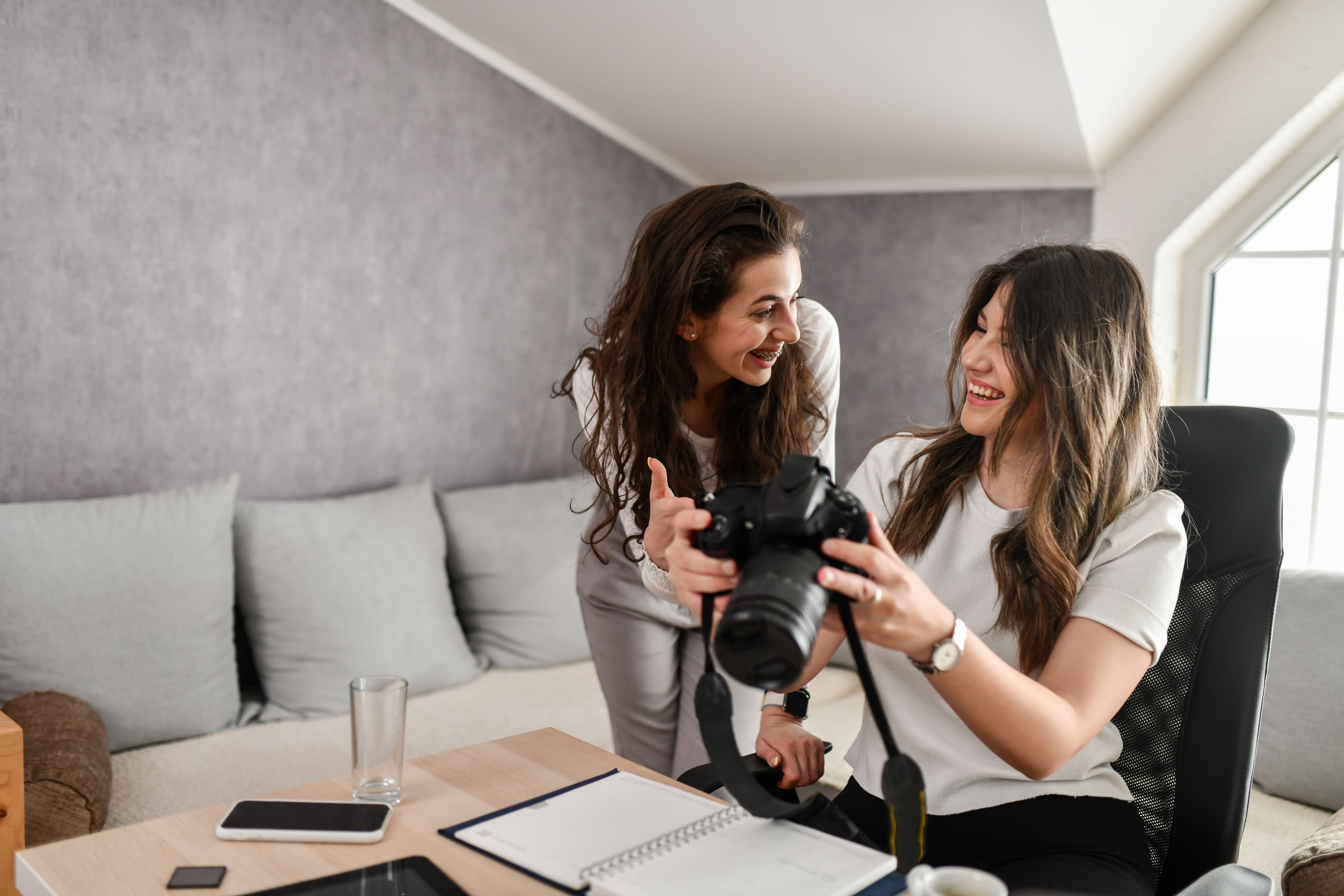 Smiling Females Laughing At Different Takes Of Their Next Vlog Episode In Camera