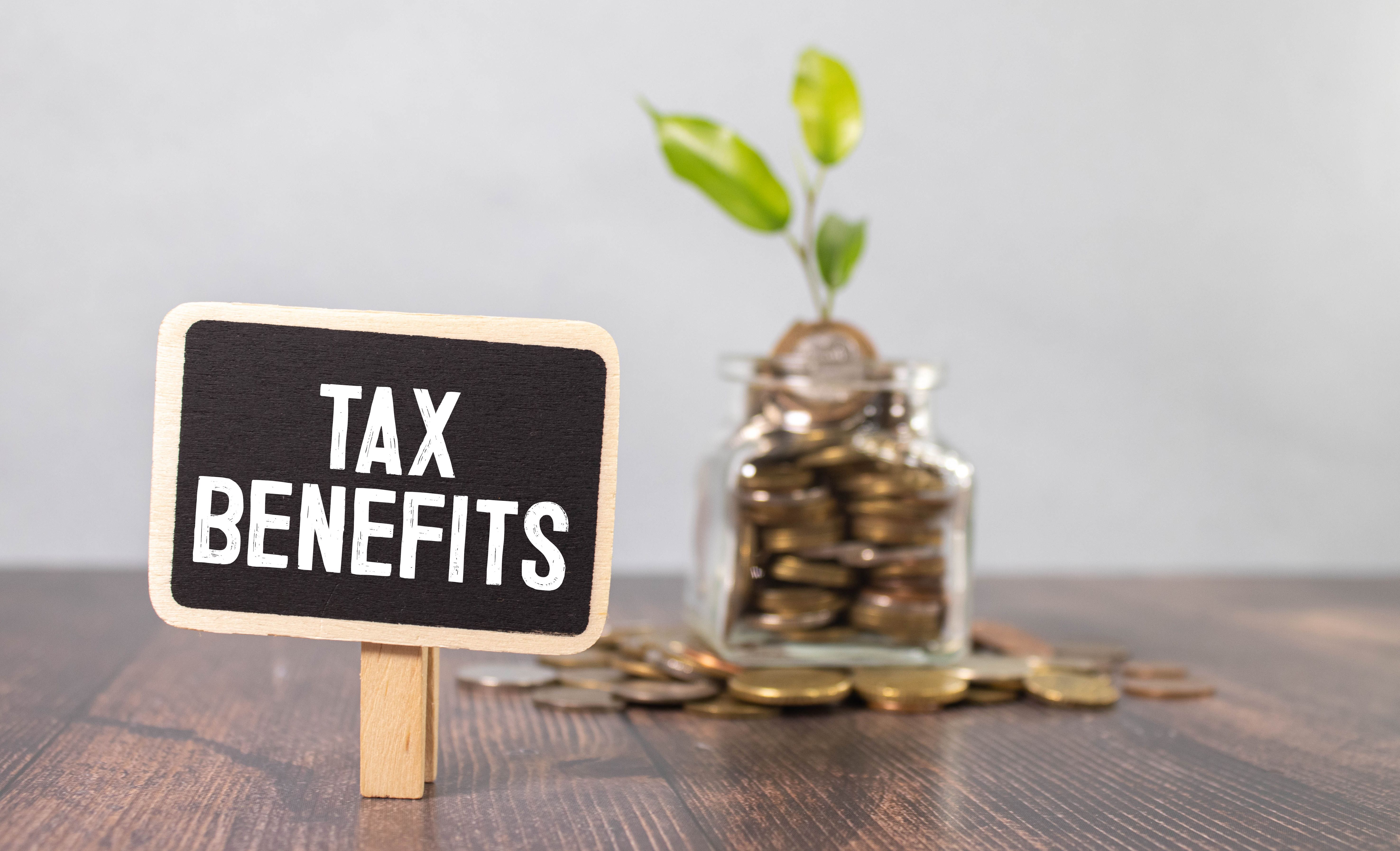On a white tablet the inscription TAX BENEFITS on the background of accounting.