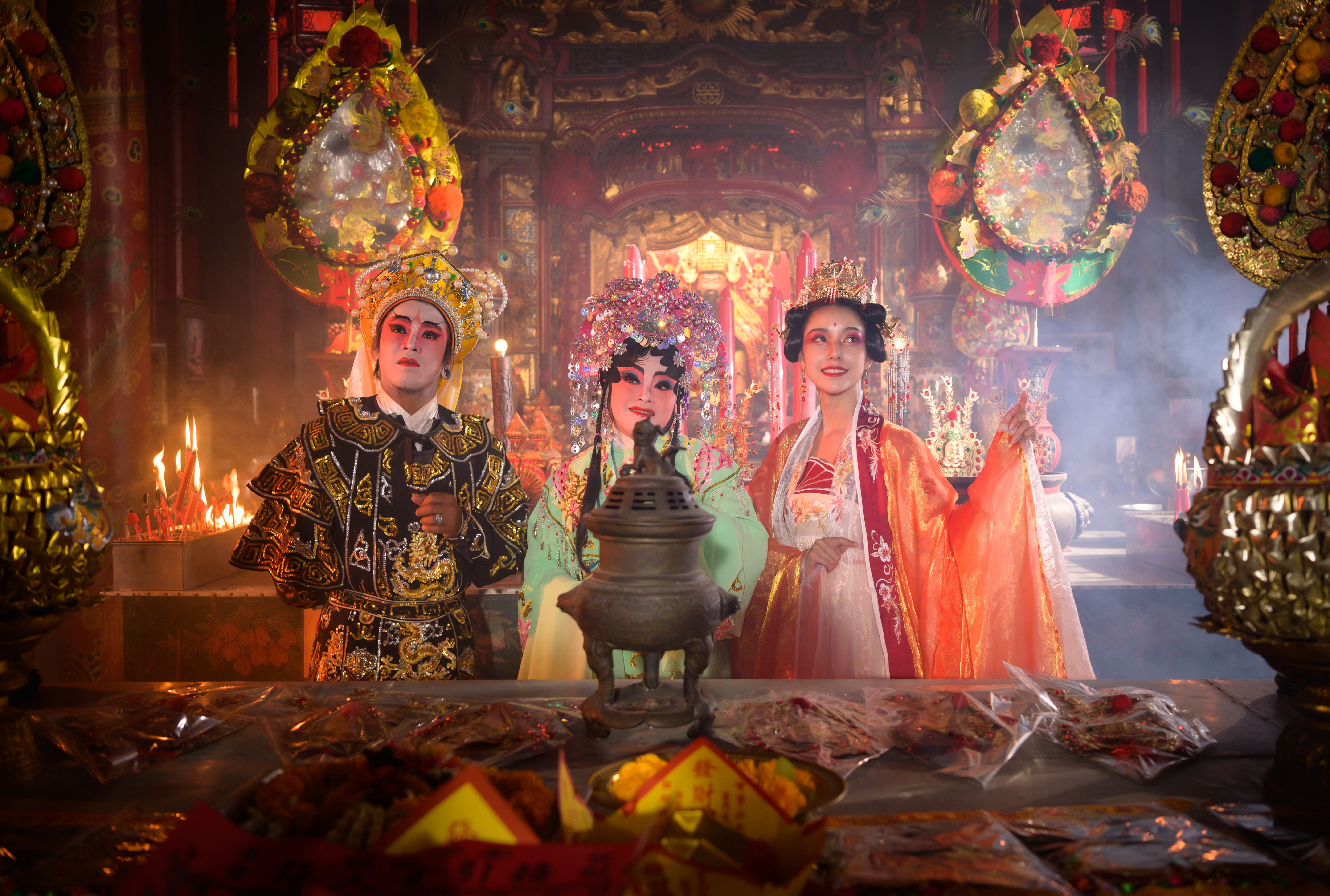 Male and female Chinese opera actors Light a candle to pray homage to the gods to enhance the prosperity for yourself on the occasion