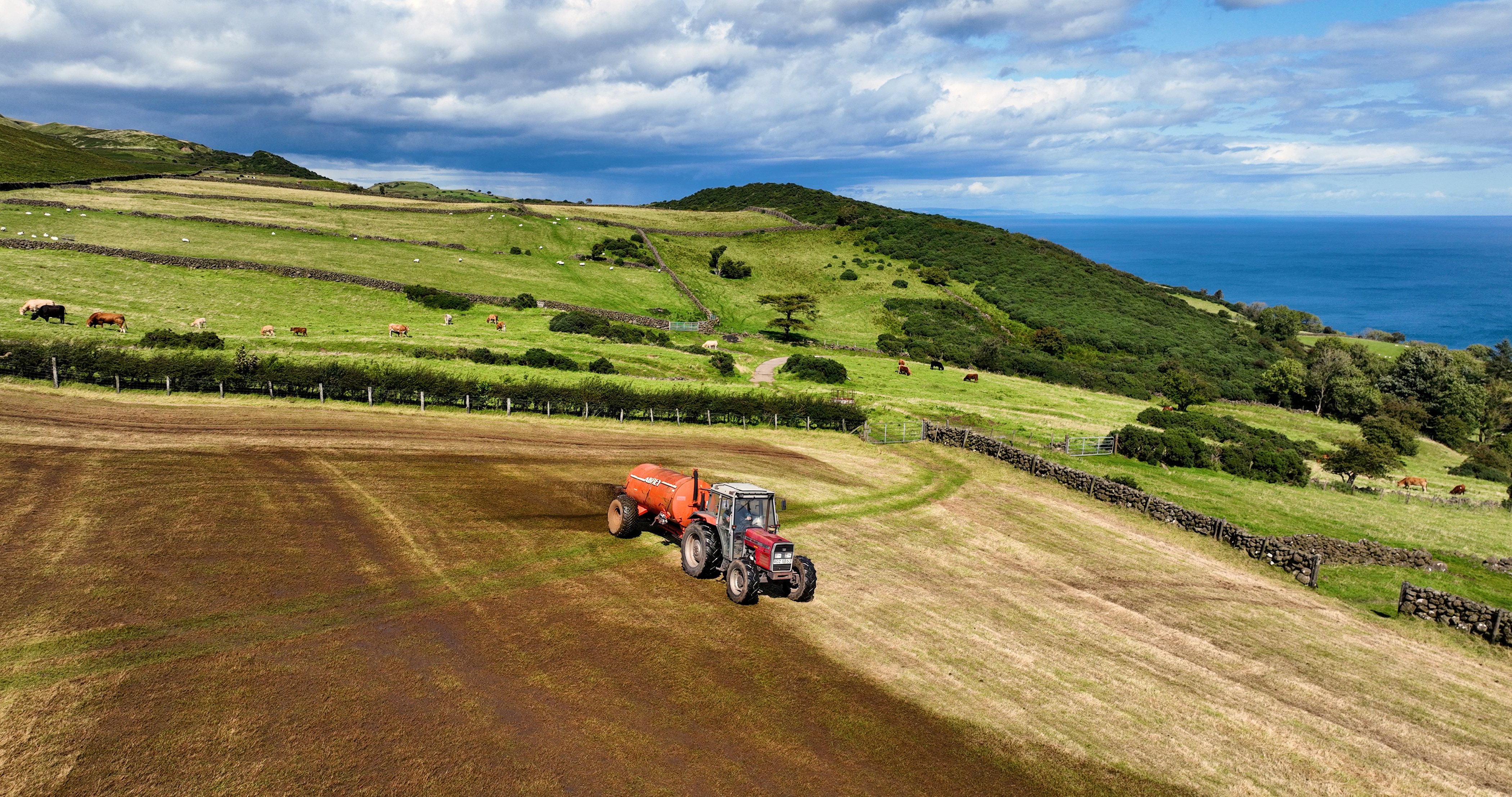 Aerial Photo of Massey Ferguson 390T Tractor and Abbey Tanker spreading manure slurry in a field on farm in UK 09-09-23 Aerial Photo of Massey Ferguson 390T Tractor and Abbey Tanker spreading manure slurry in a field on farm in UK 09-09-23