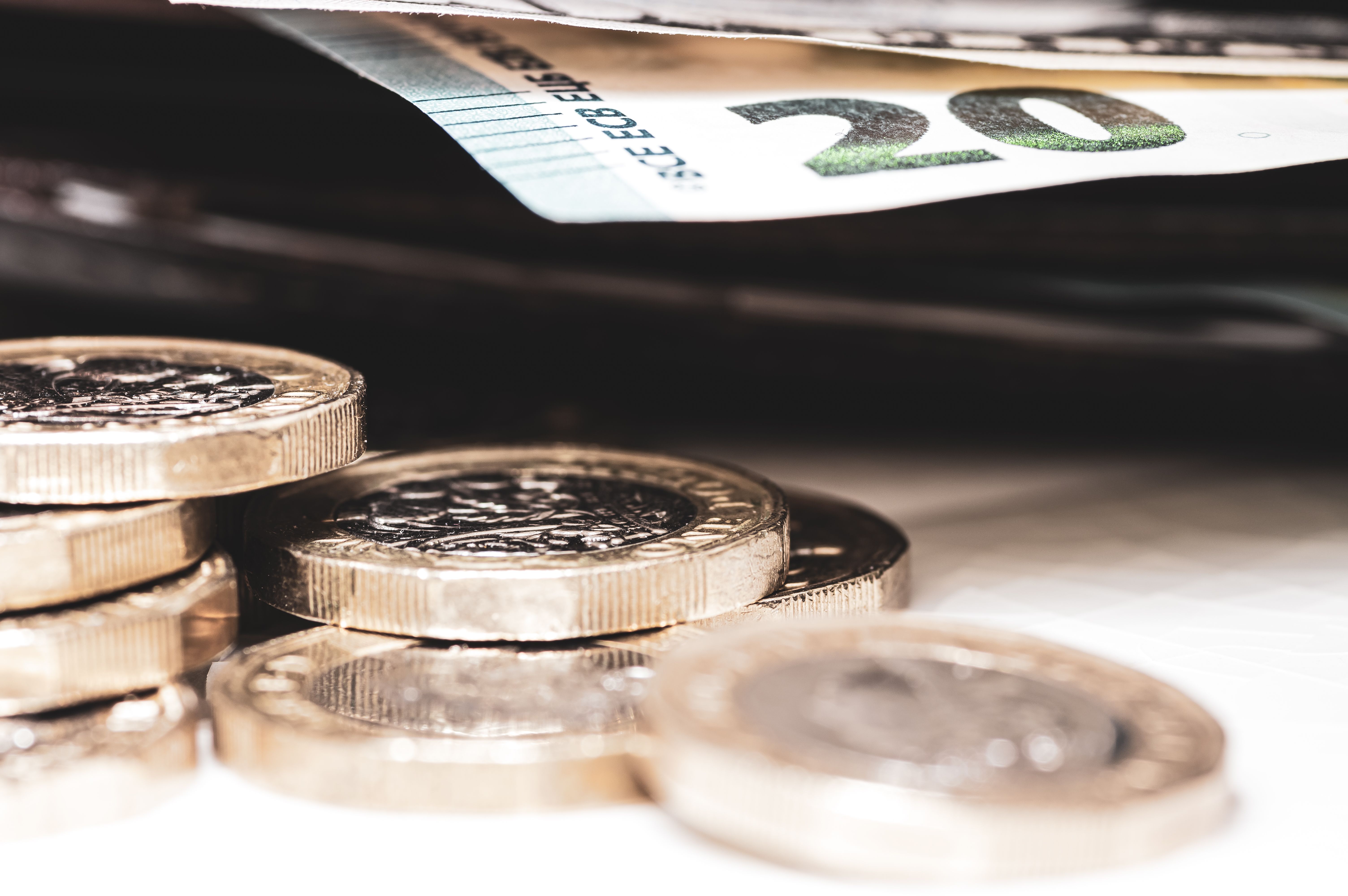 British pound coins, a twenty Euro note and a wallet