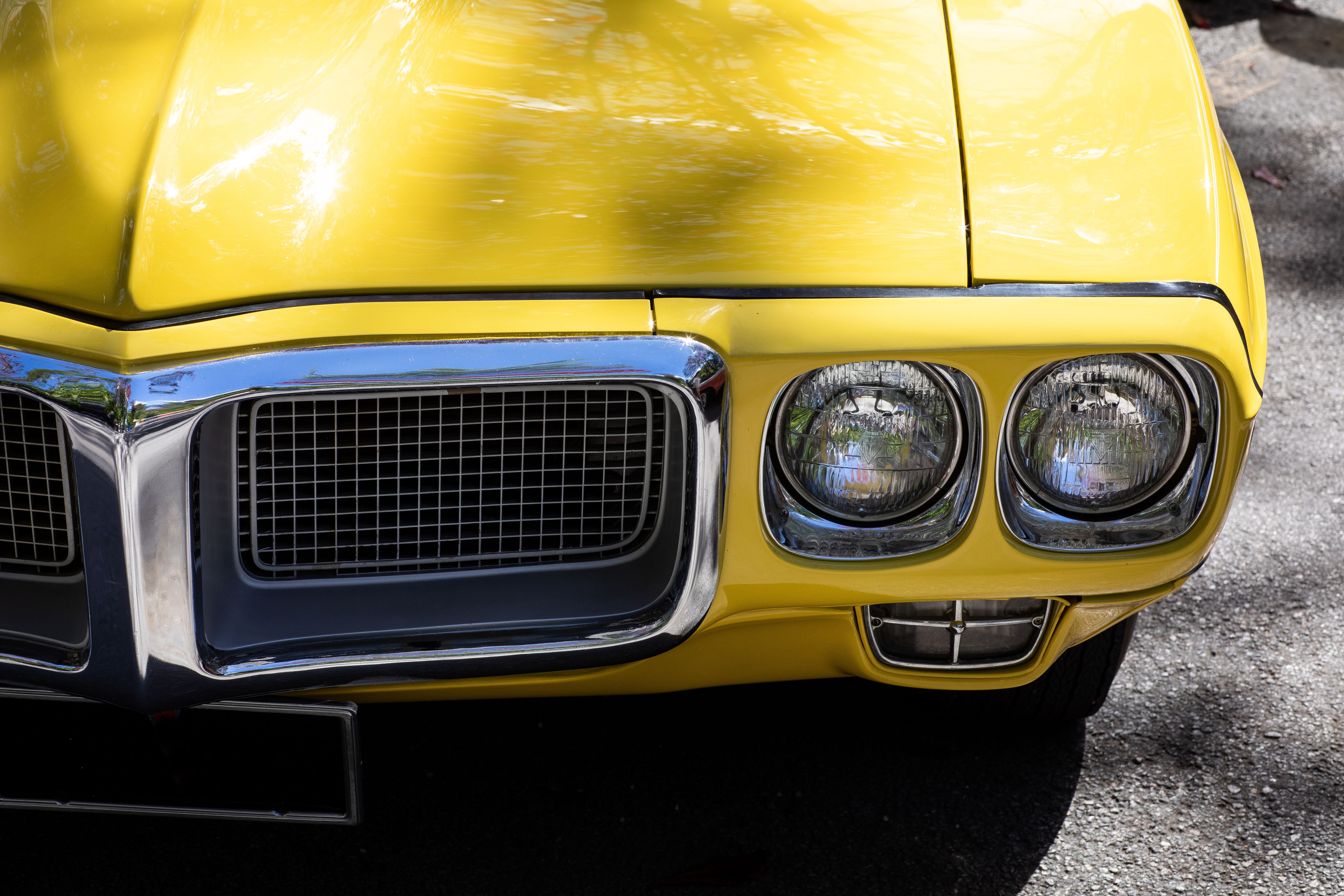 detail of front of vintage yellow sports car