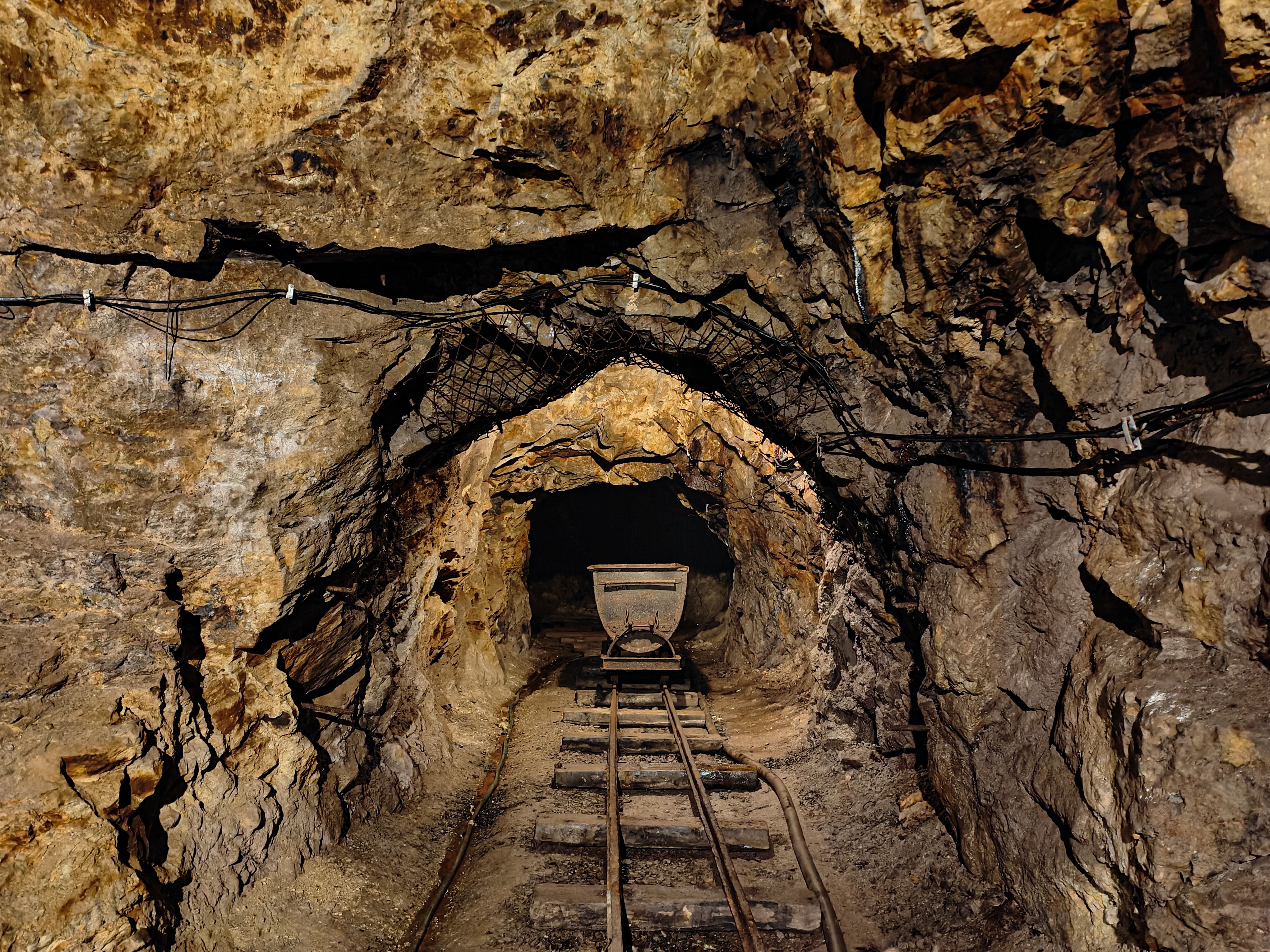 Old underground mine tunnel, mining cart and tracks