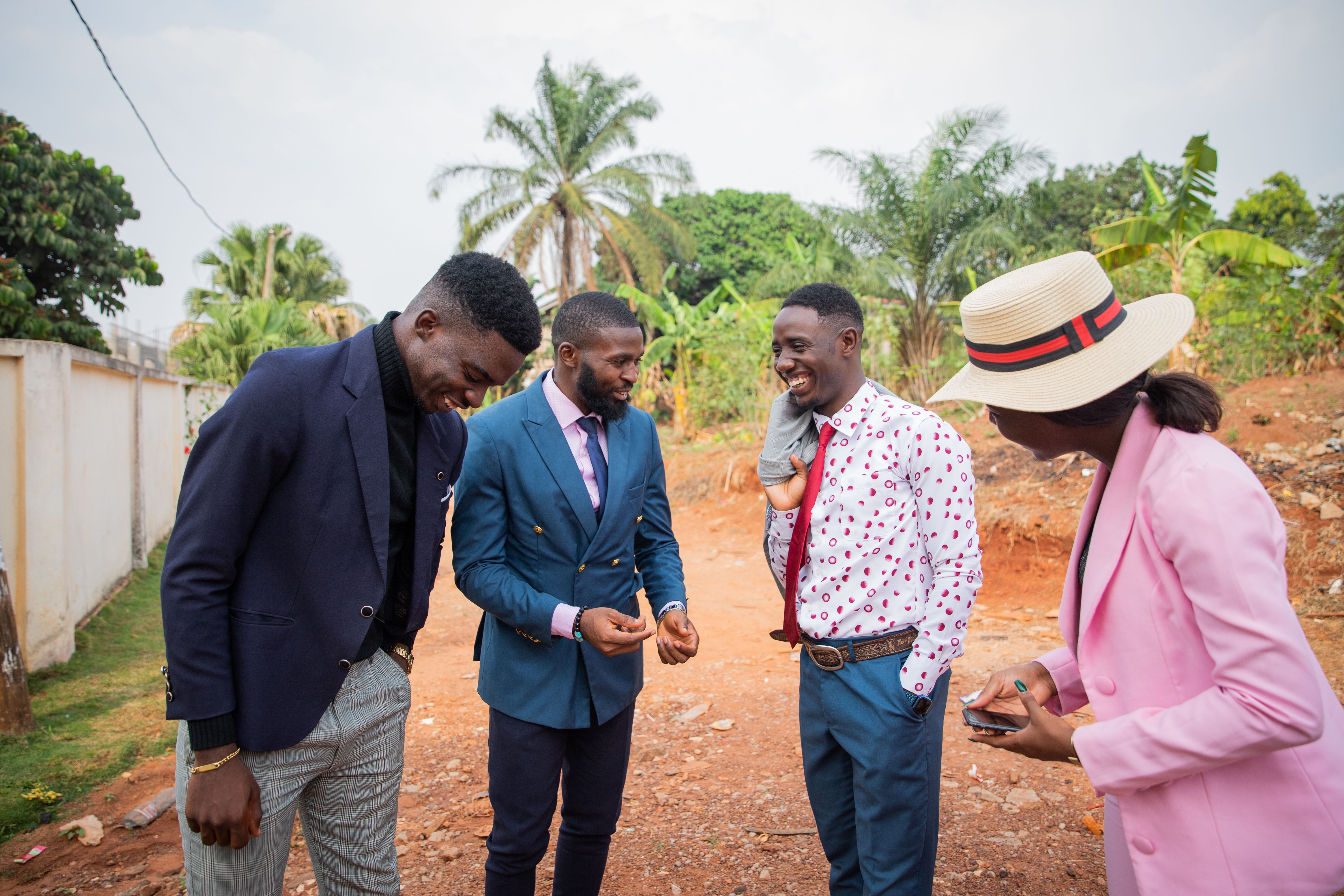 Four business people get together during a meeting to discuss and laugh together, a moment of happiness between well-dressed friends