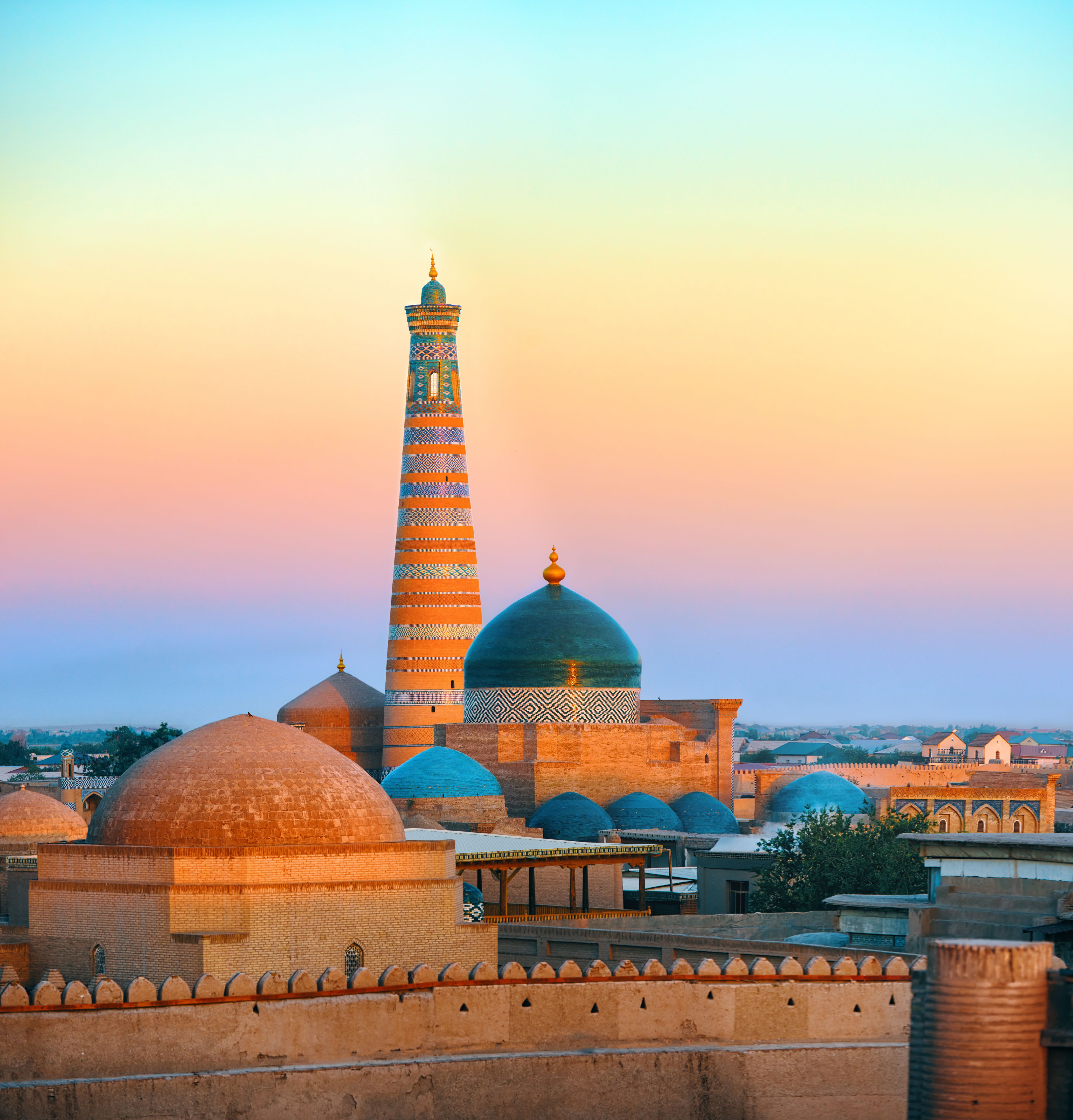 Minaret and madrasah of Islam-Khoja of the ancient city of Khiva at the sunrise, Uzbekistan.