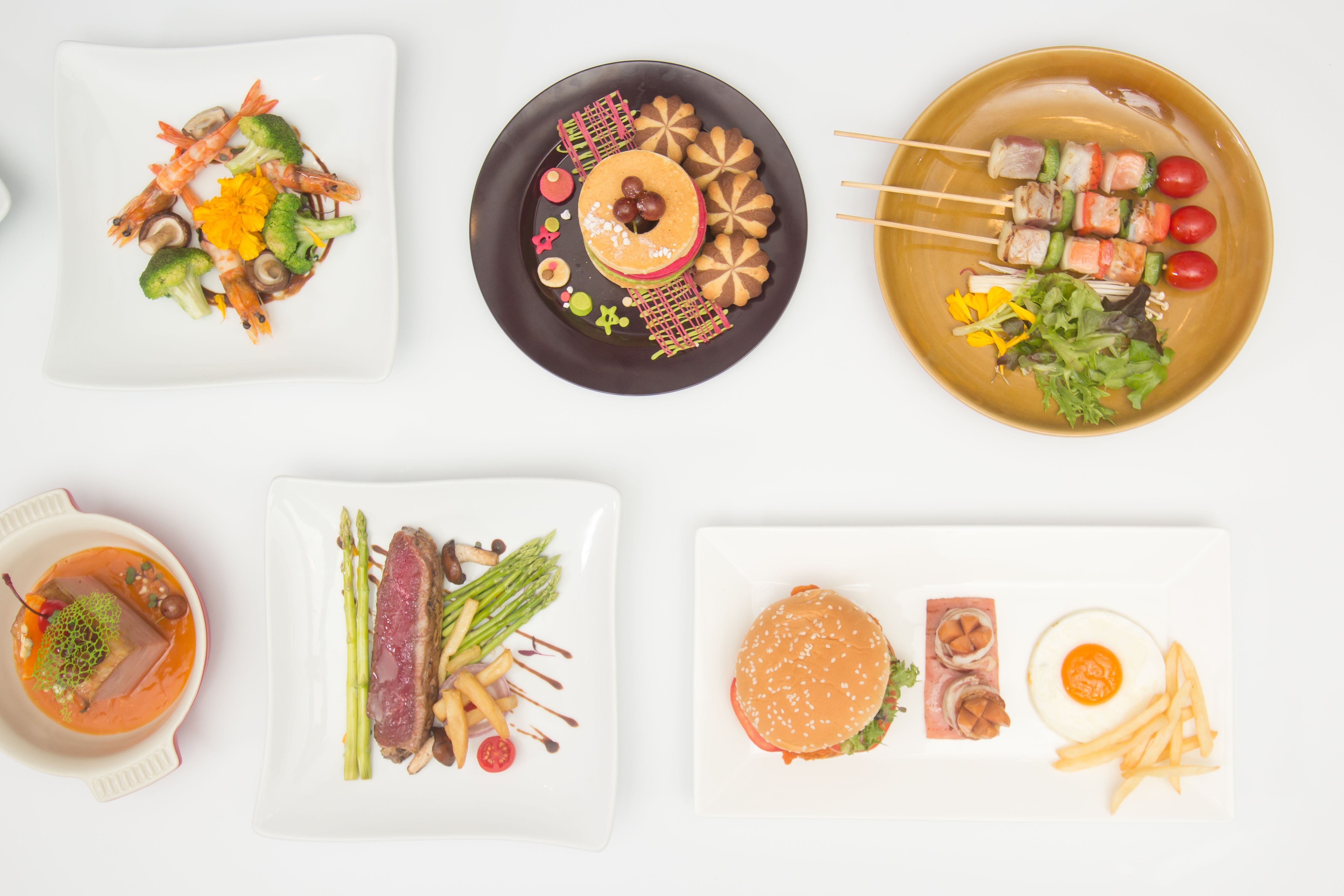 Variety Of Food Served In Plates On Table Variety Of Food Served In Plates On Table