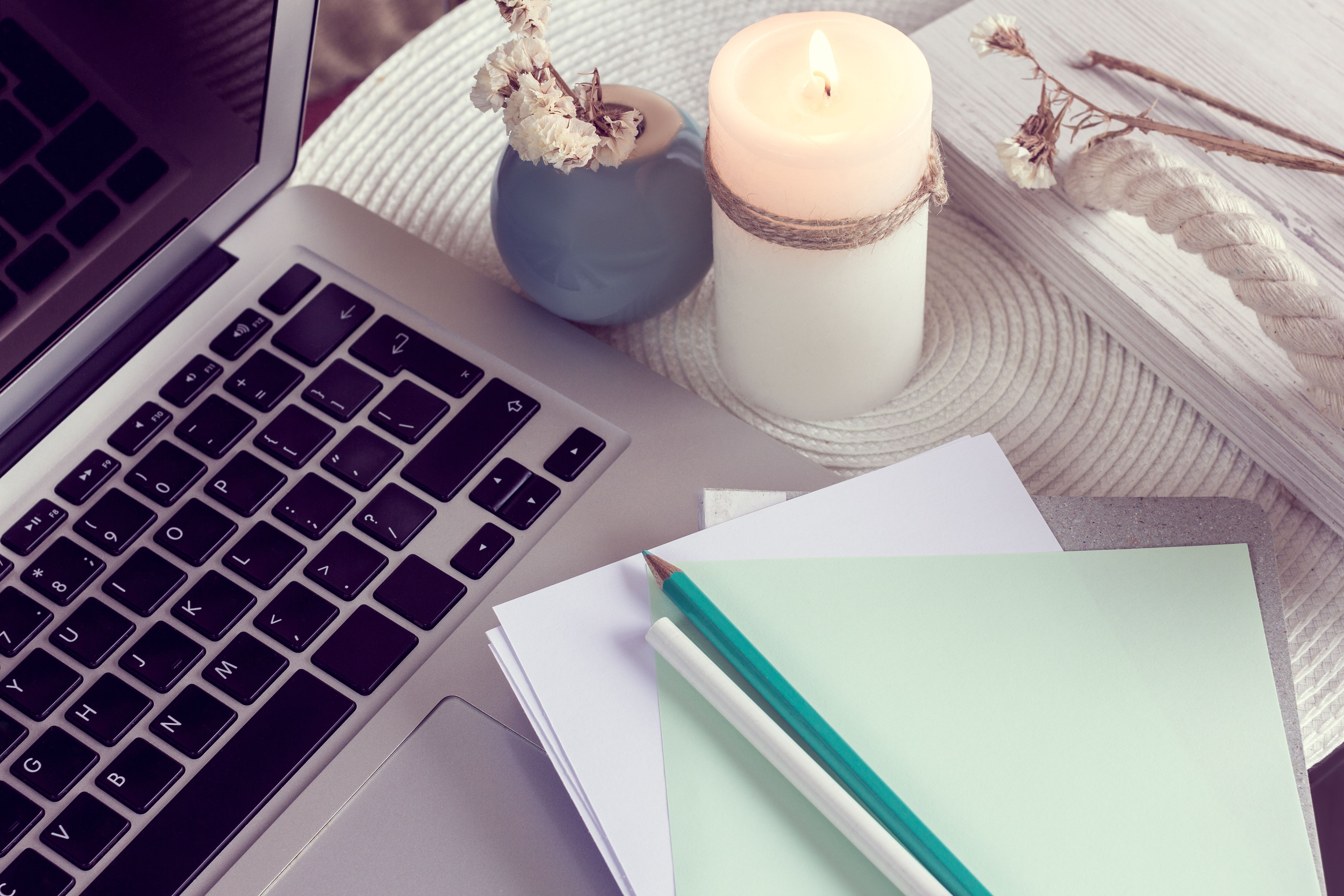 work desk with notebook, laptop and candle work desk with notebook, laptop and candle