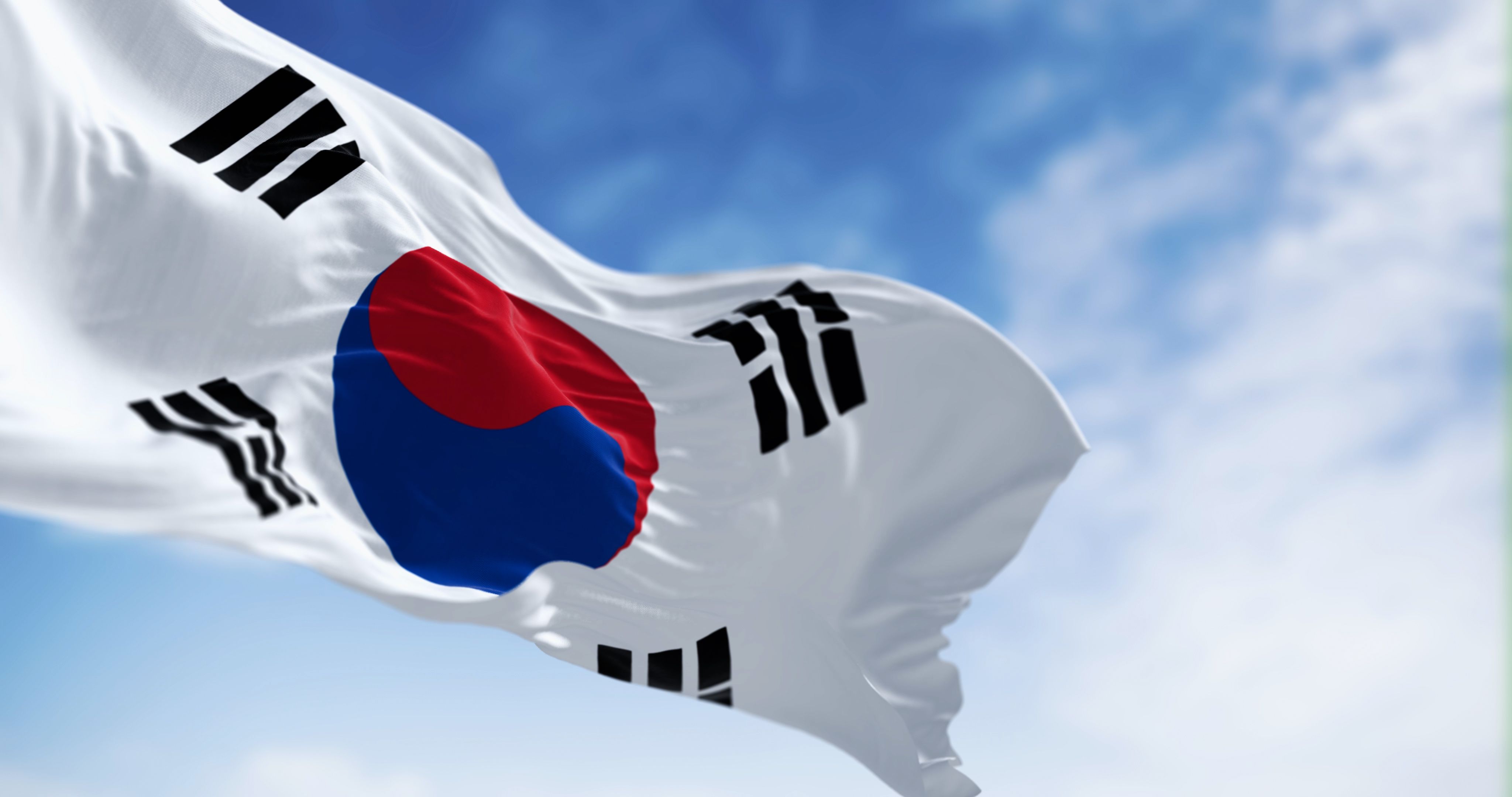 Close-up of national flag of South Korea waving on a clear day Close-up of national flag of South Korea waving on a clear day