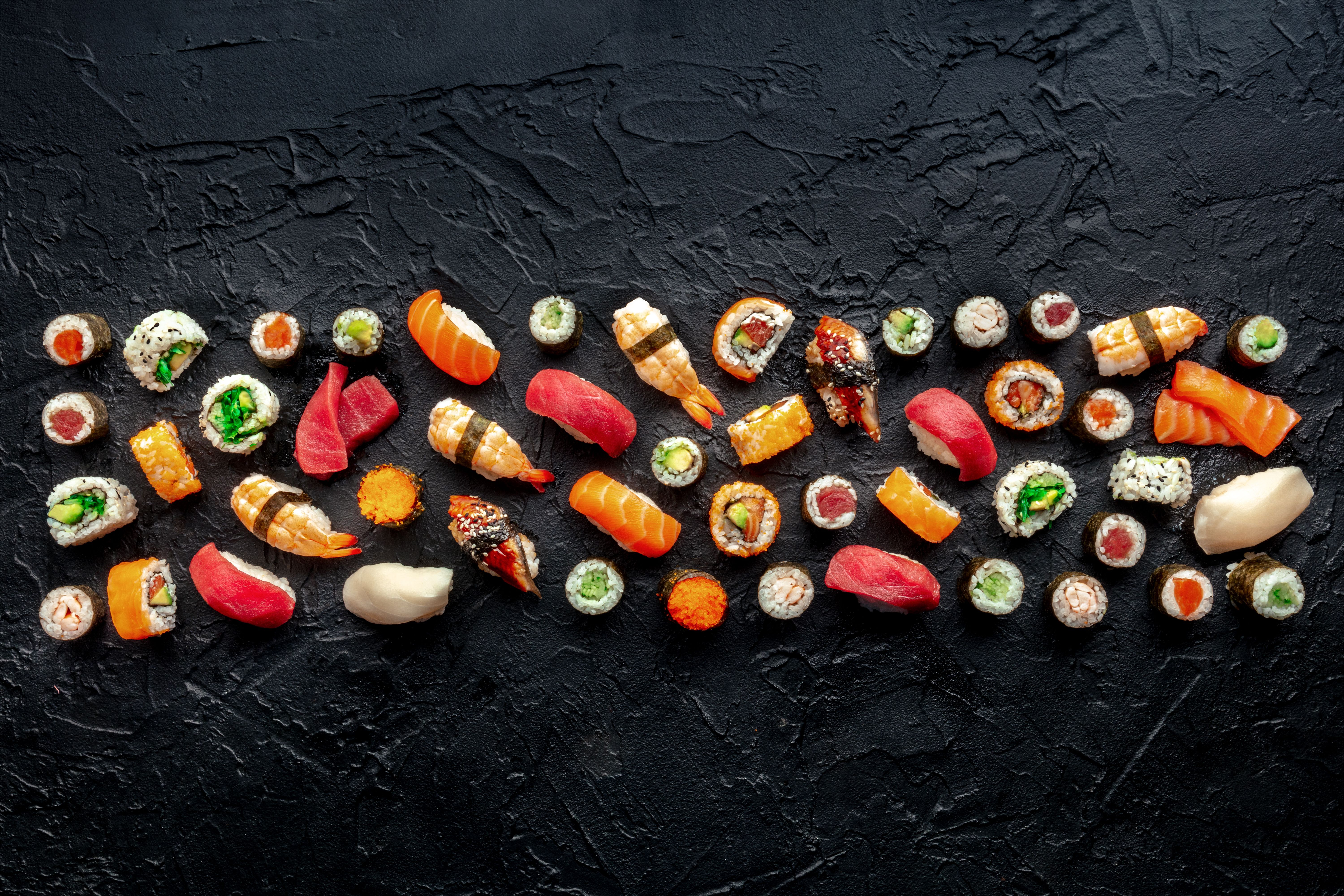 Sushi. An assortment of rolls, maki, nigiri etc, overhead flat lay composition