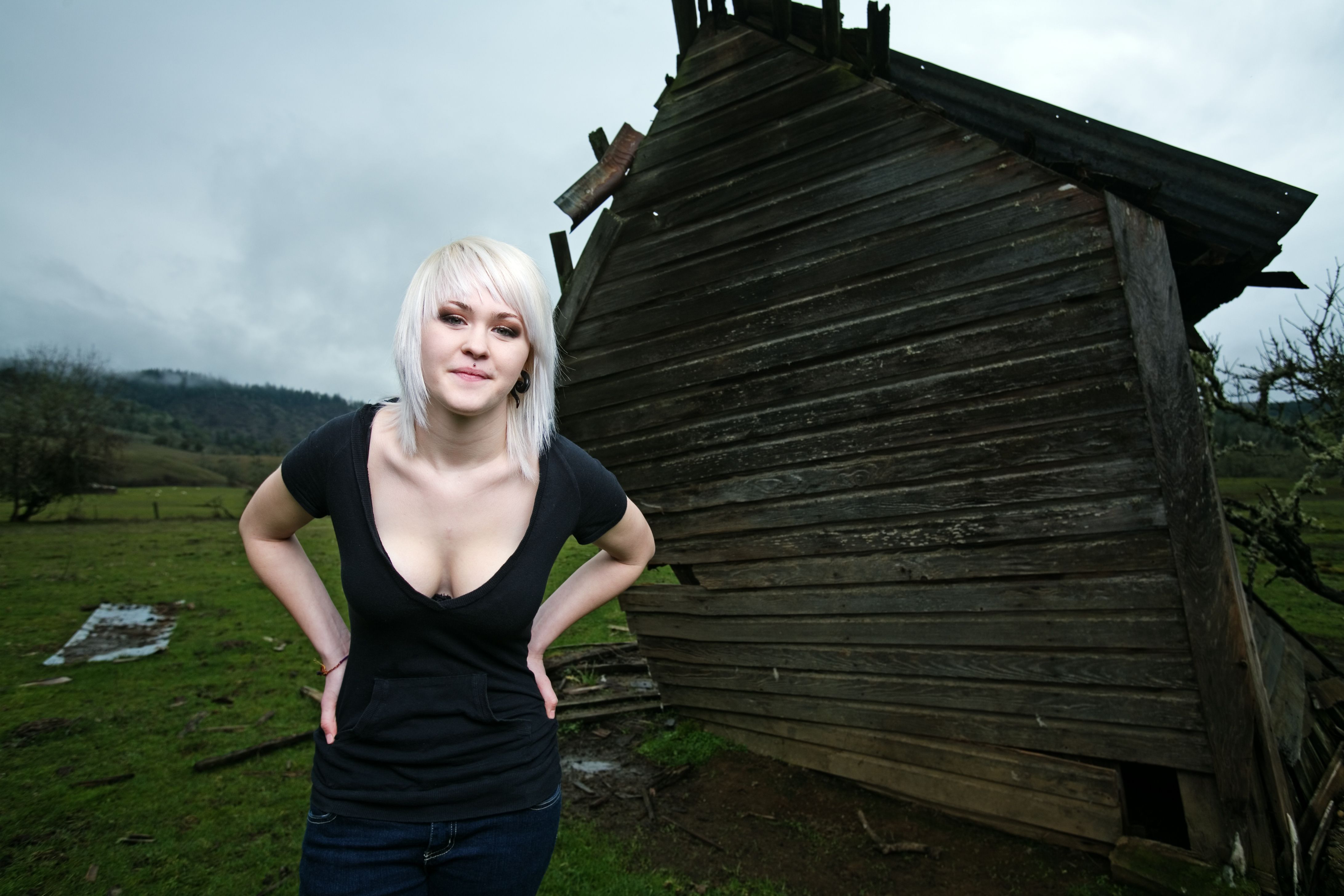 Blonde Girl Standing Next to Shack