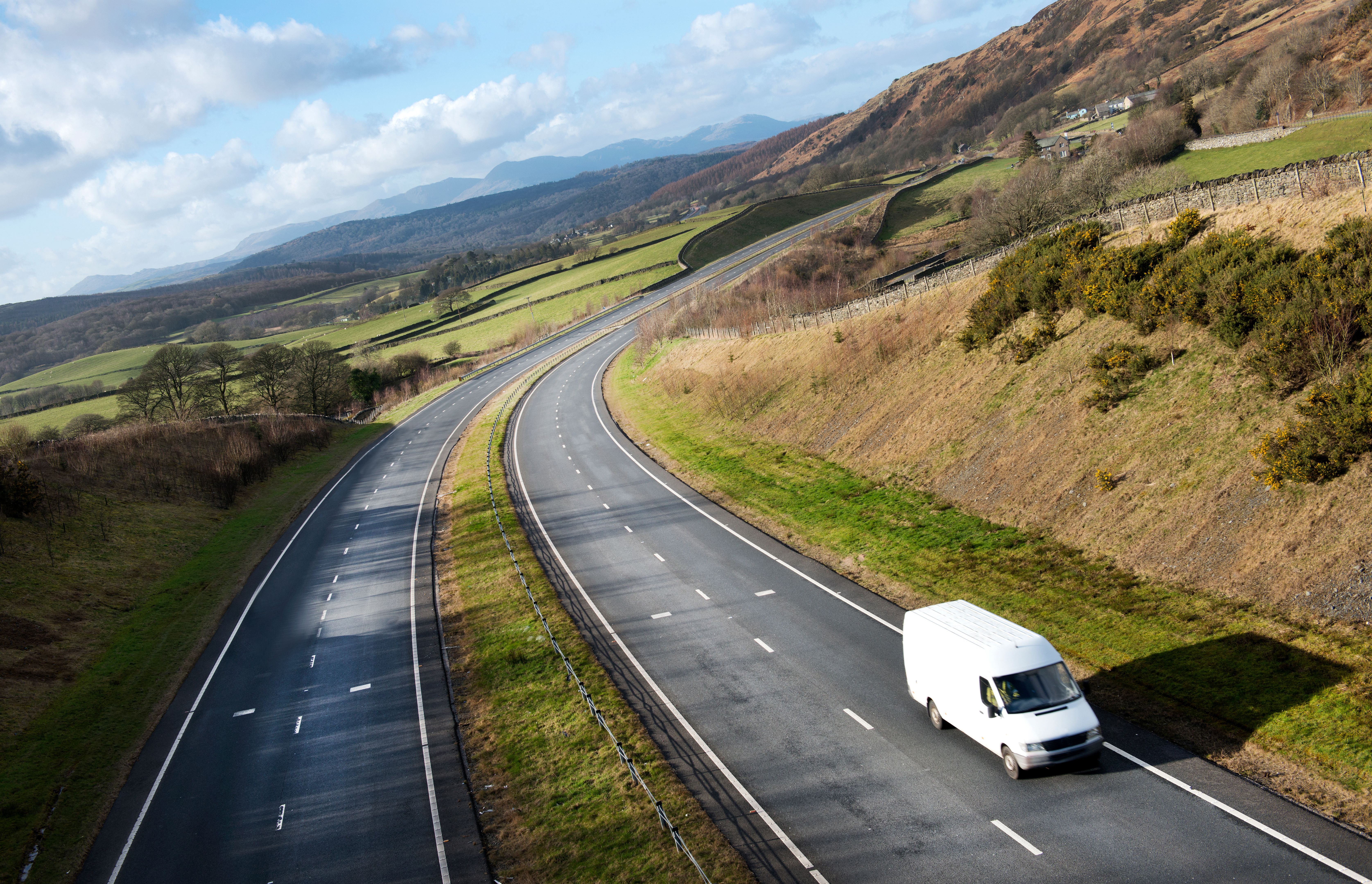 White van on Open Road in Rural Area