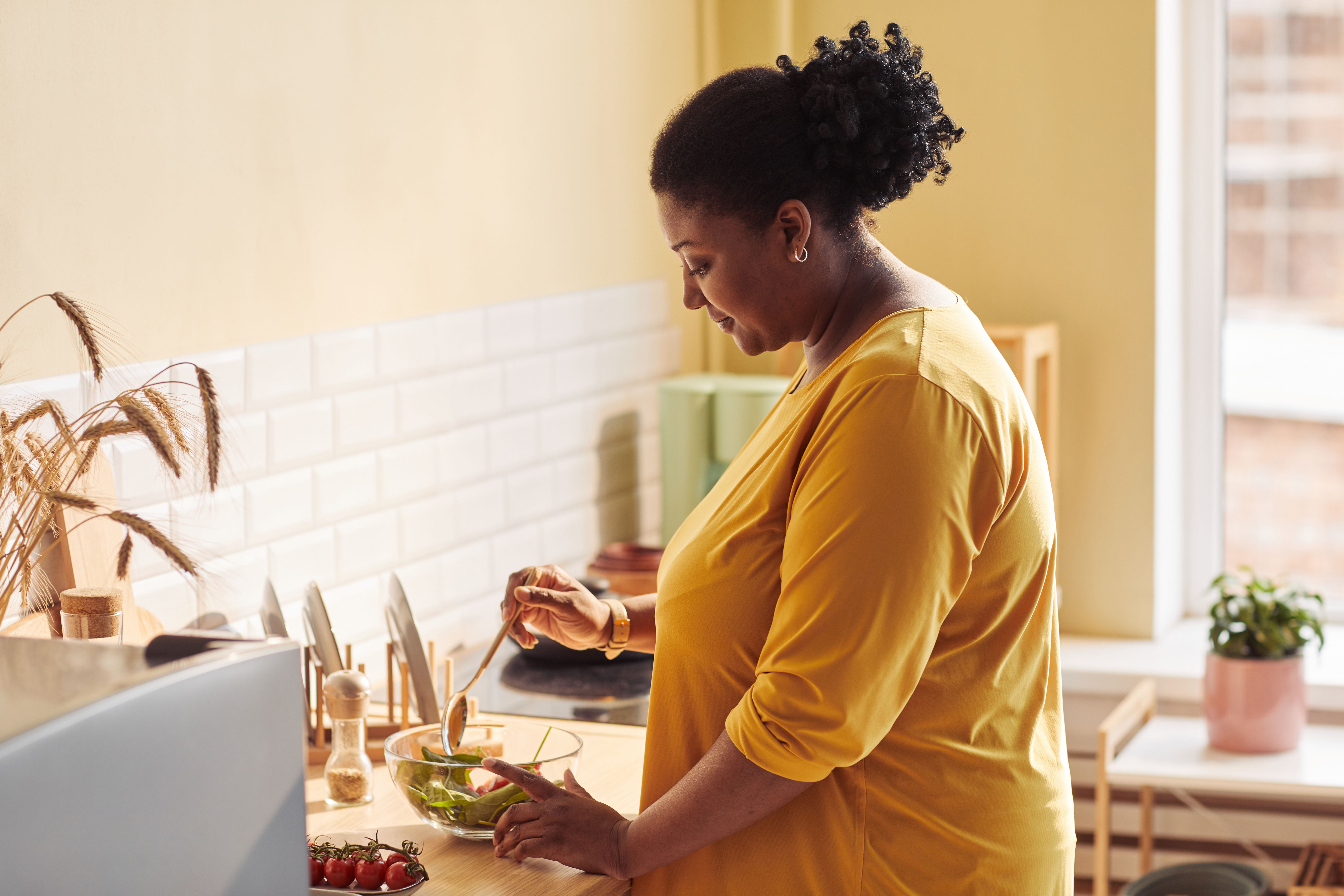 Black Woman Cooking in Cozy Kitchen