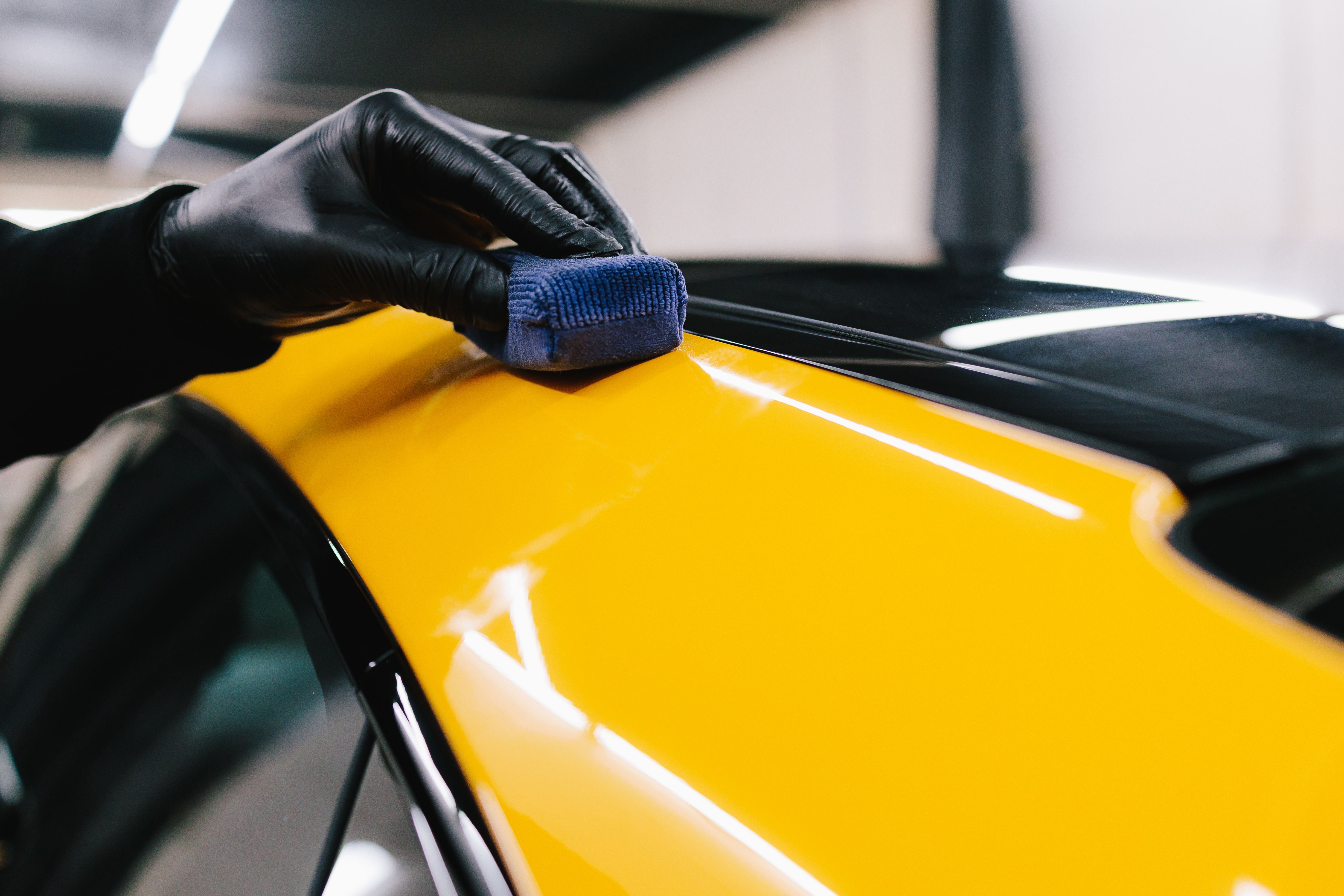 car detailer applying film