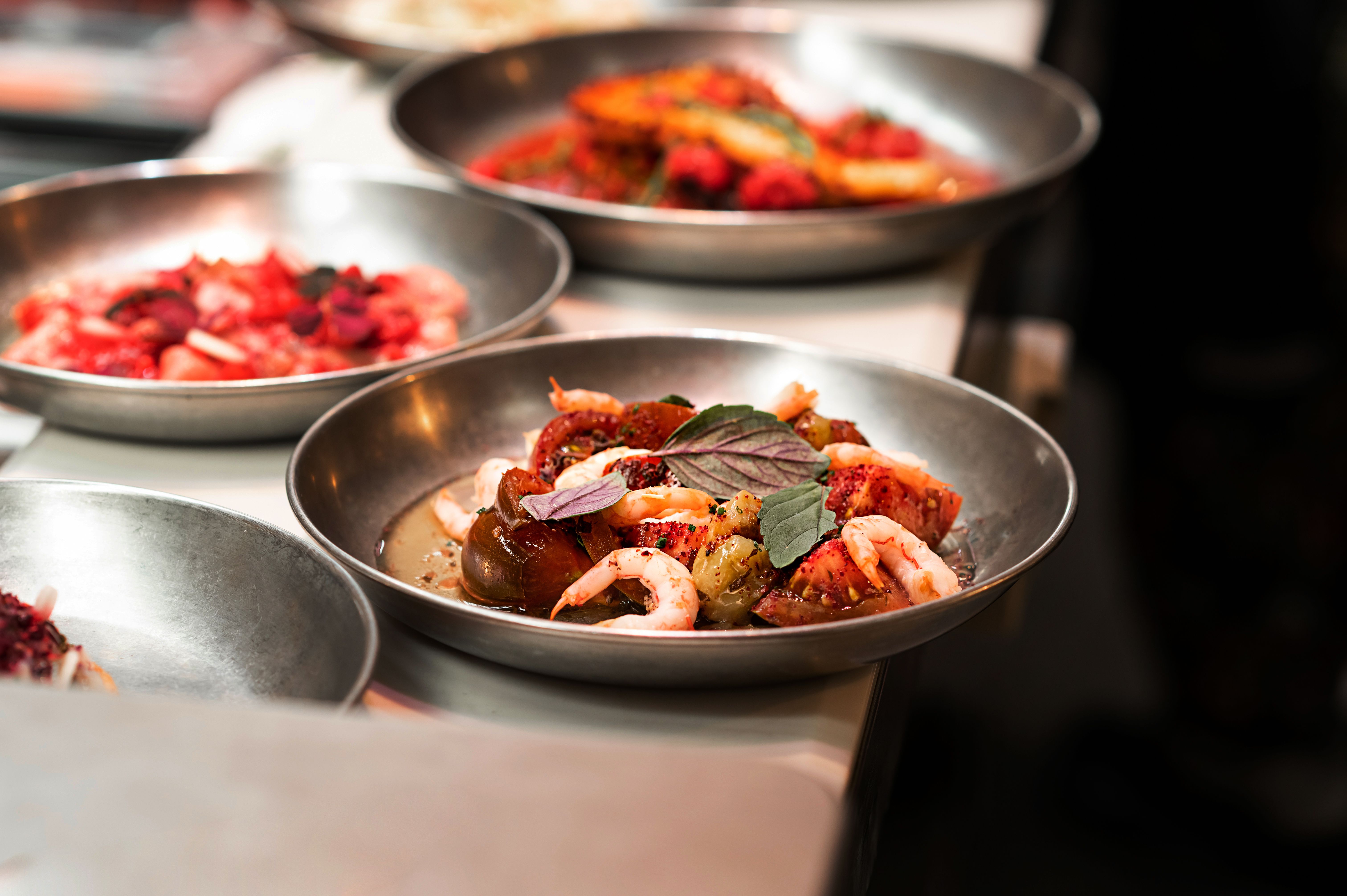 Street food prawn dish, cooked shrimps with vegetables on the table, fast food meal.