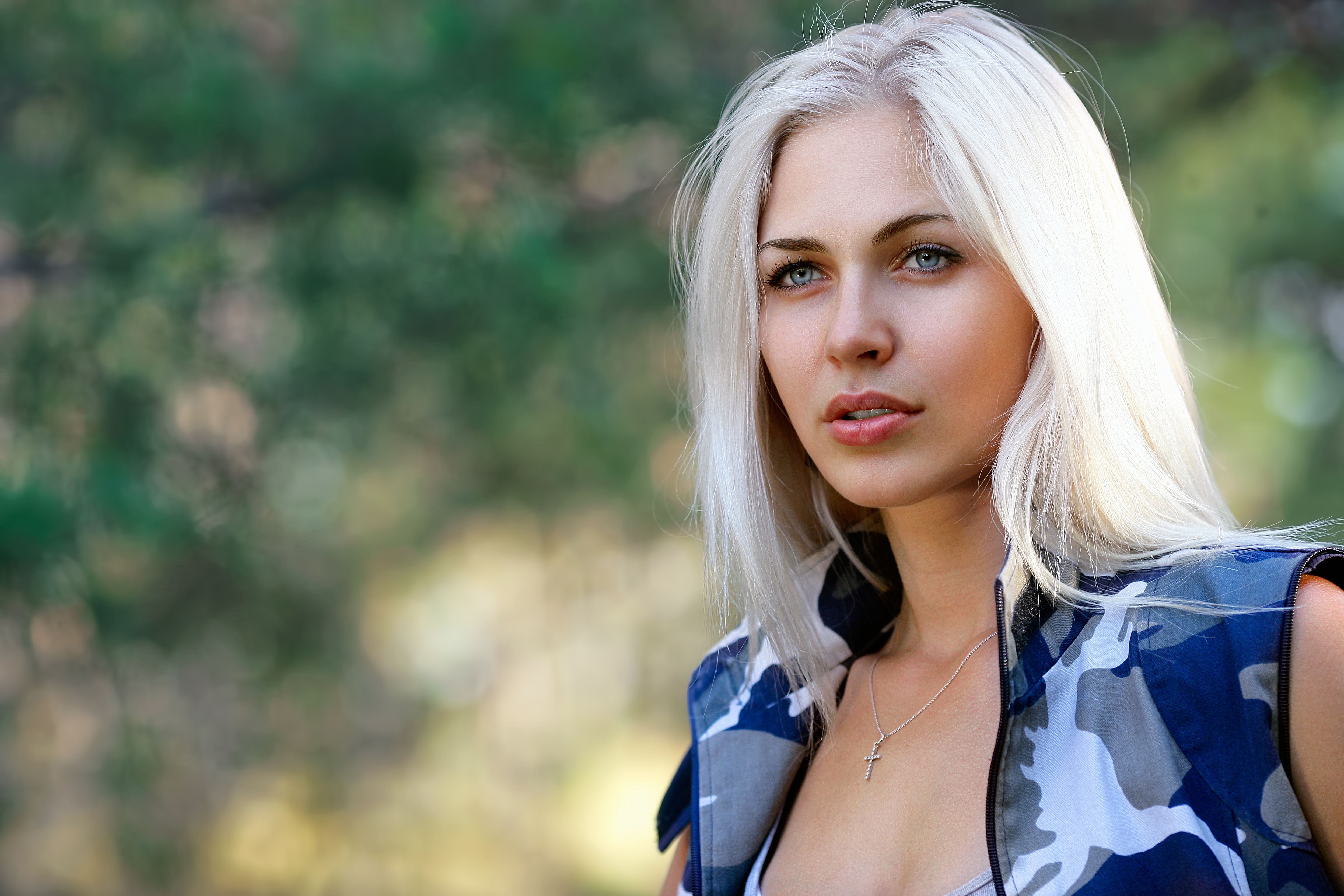 Portrait of beautiful blonde woman in camouflage