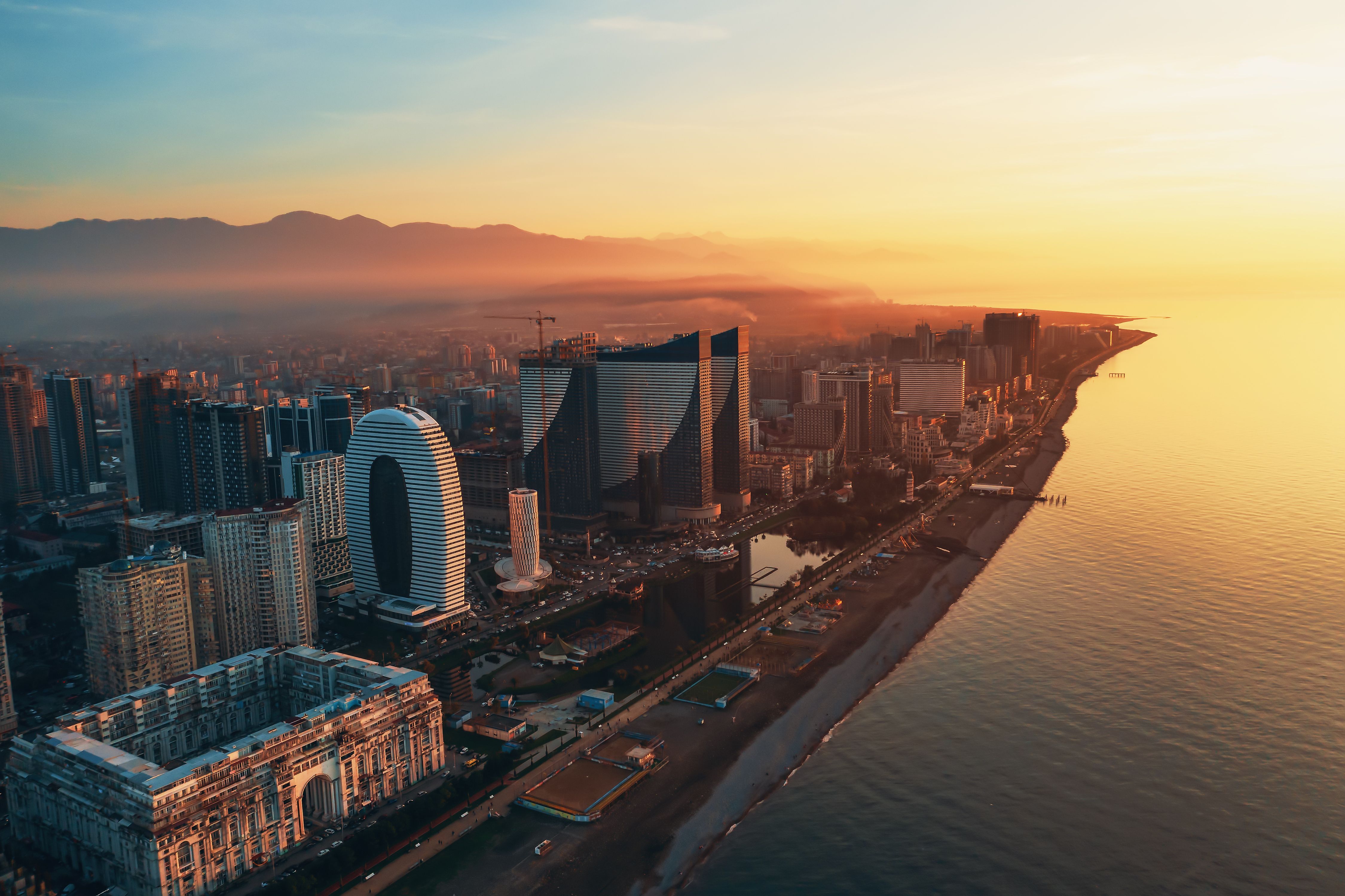 Aerial view of Batumi, Adjara, Georgia. Modern skyscrapers and hotels on coastline at sunset over Black Sea