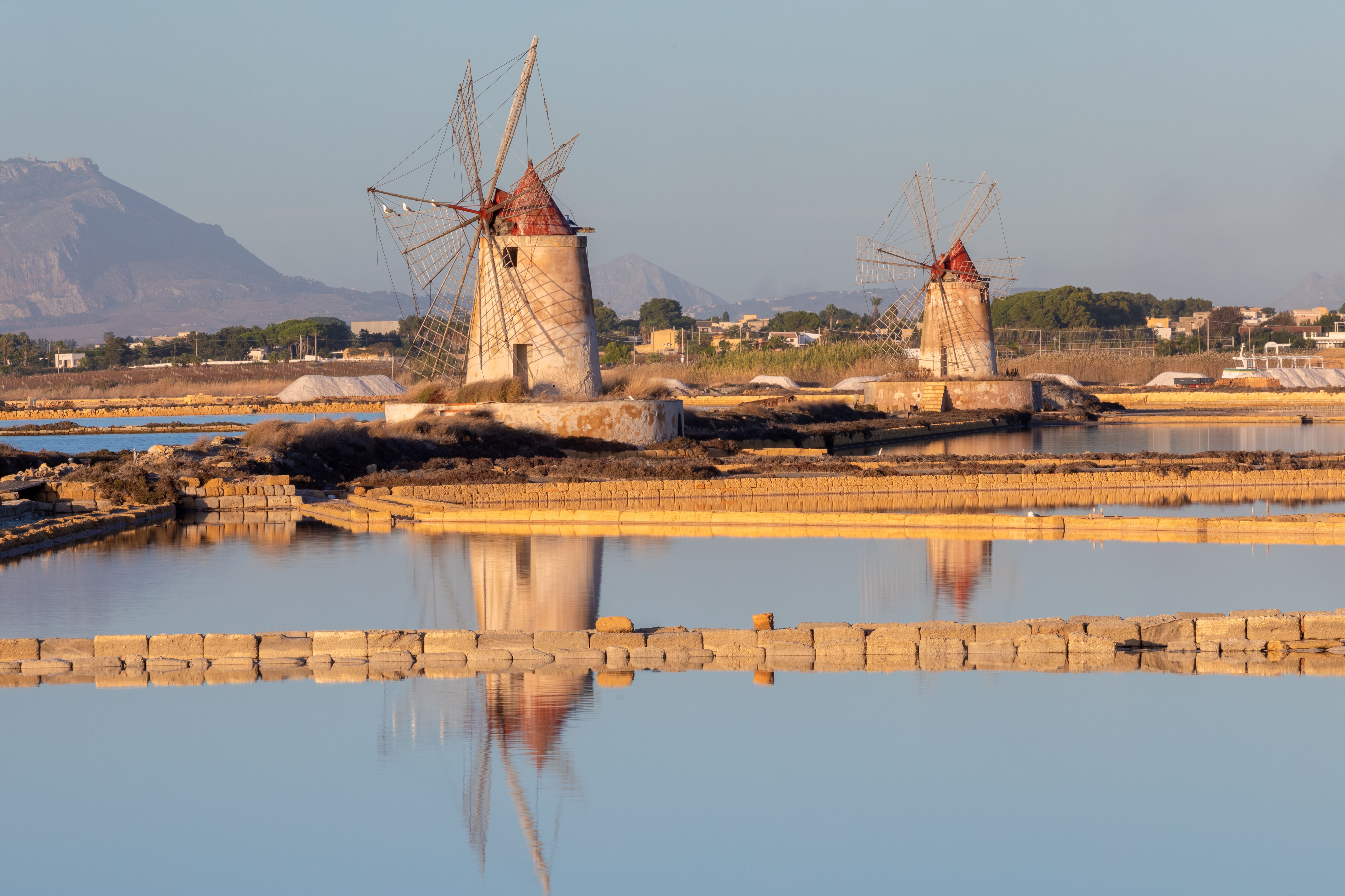 Sunset at Windmills in the salt evoporation pond in Marsala, Sicily island, Italy
Trapani salt flats and old windmill in Sicily.
View in beautifull sunny day.