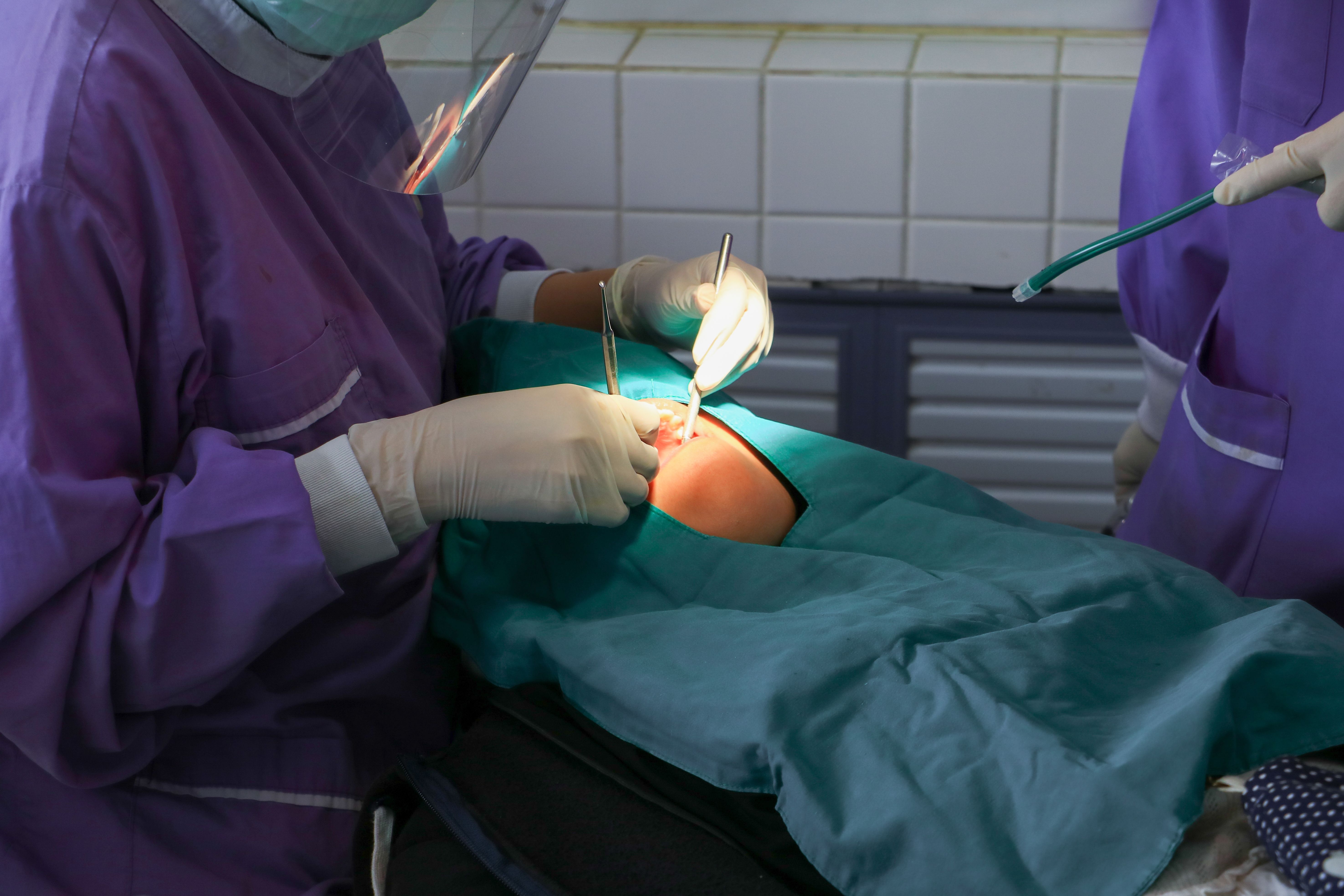 dentist examining a patient teeth in medical treat dental