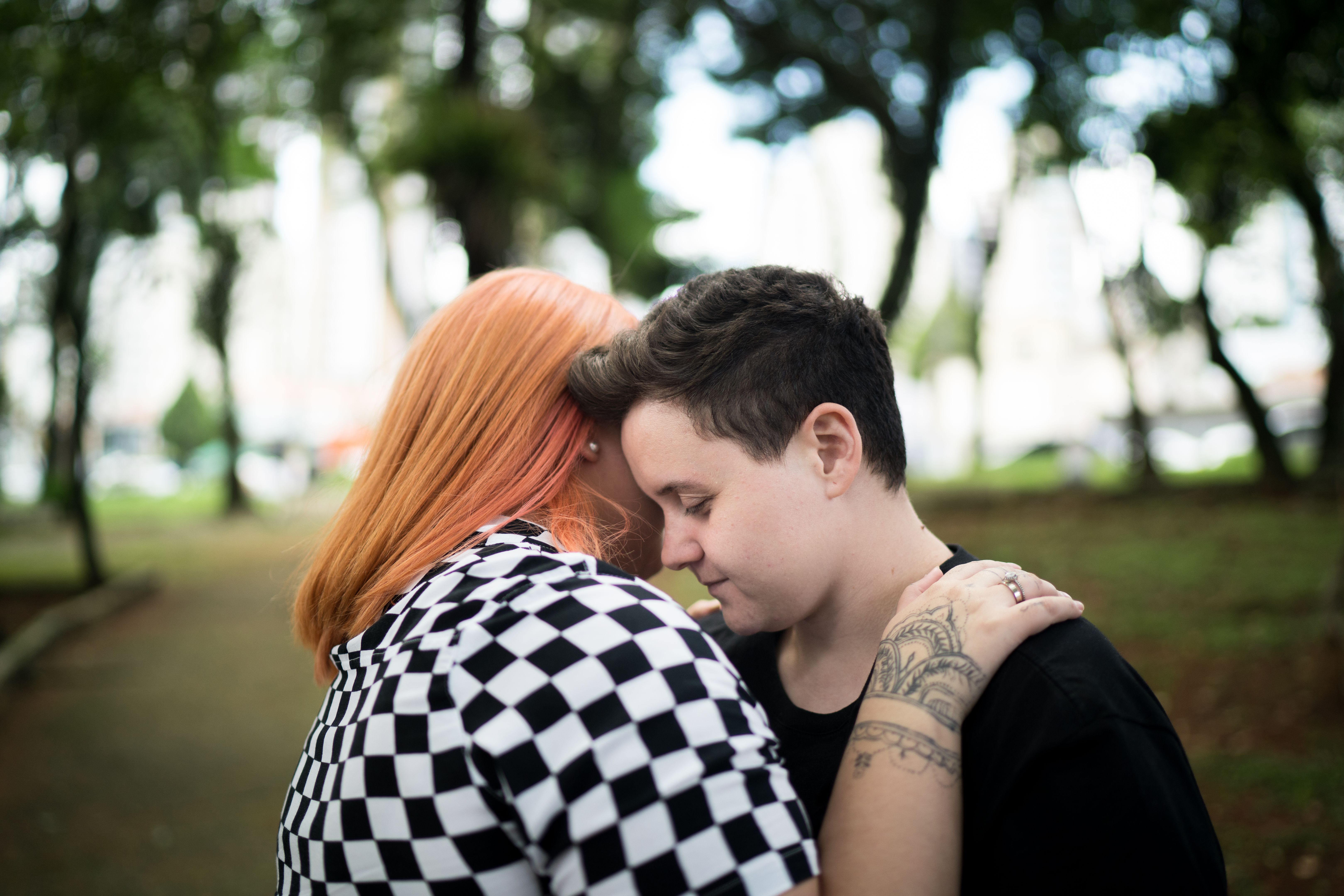 Lesbian couple embracing at park