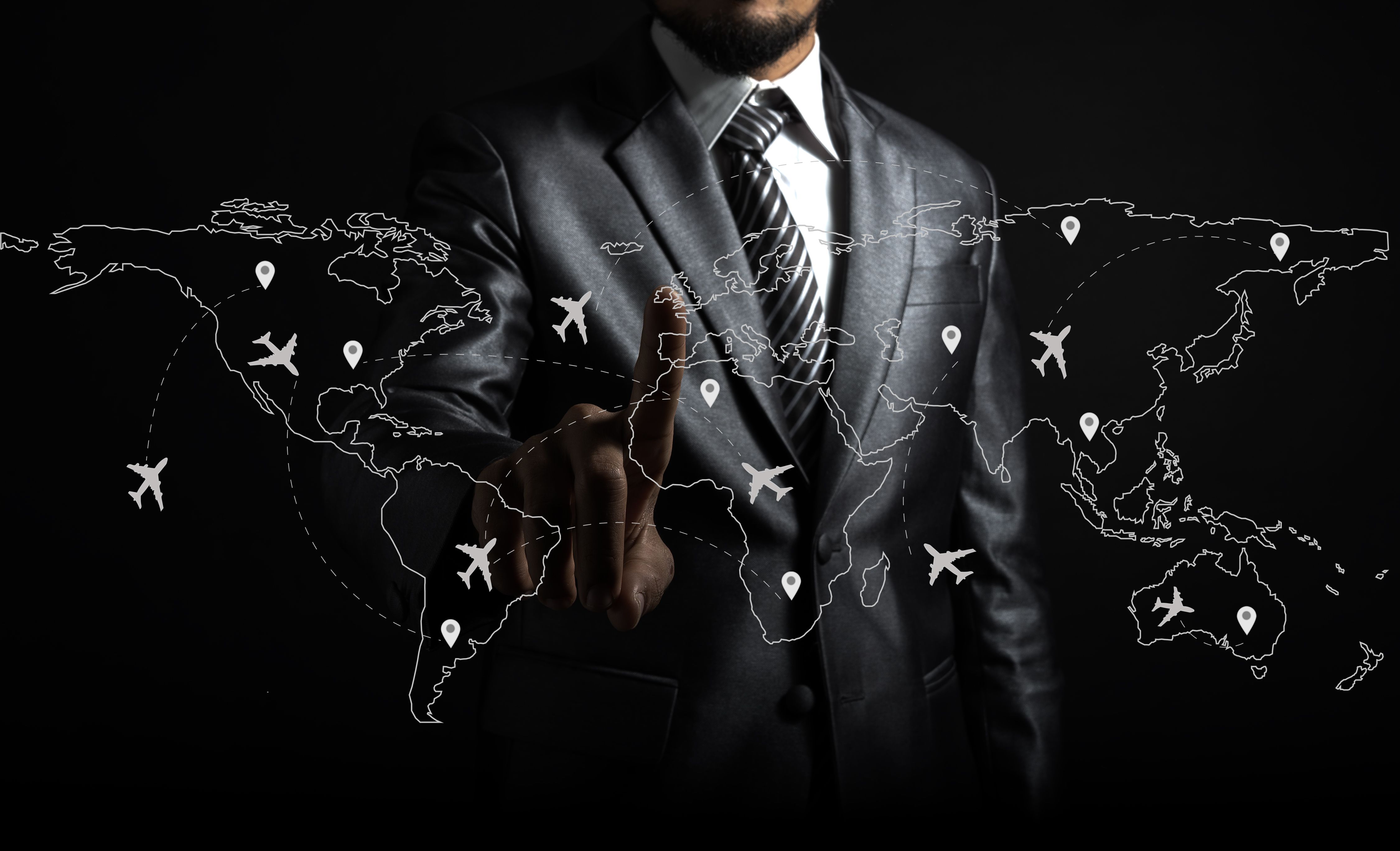 Businessman and airplane routes on world map