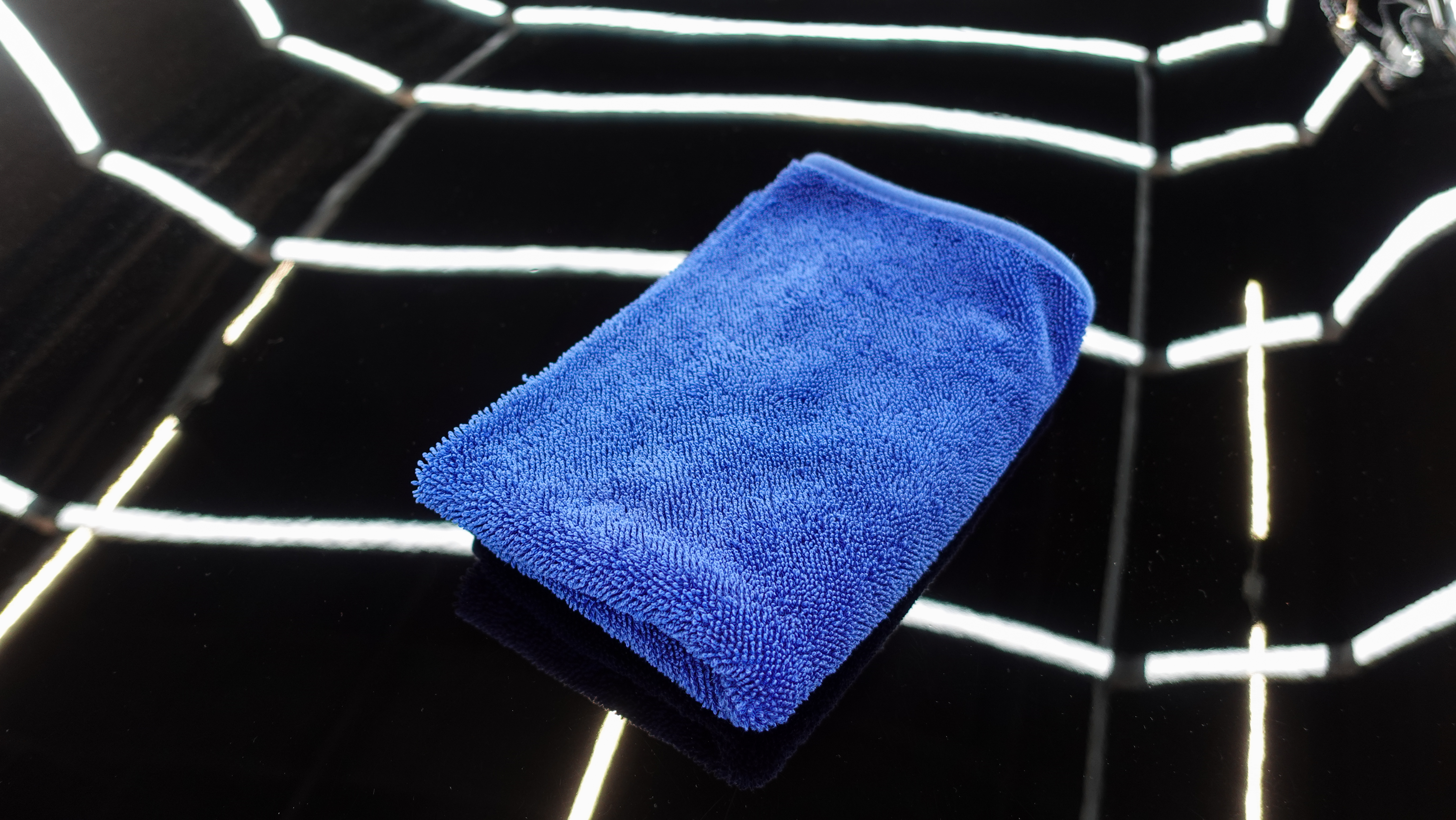 Blue cloth for wiping the car on the hood